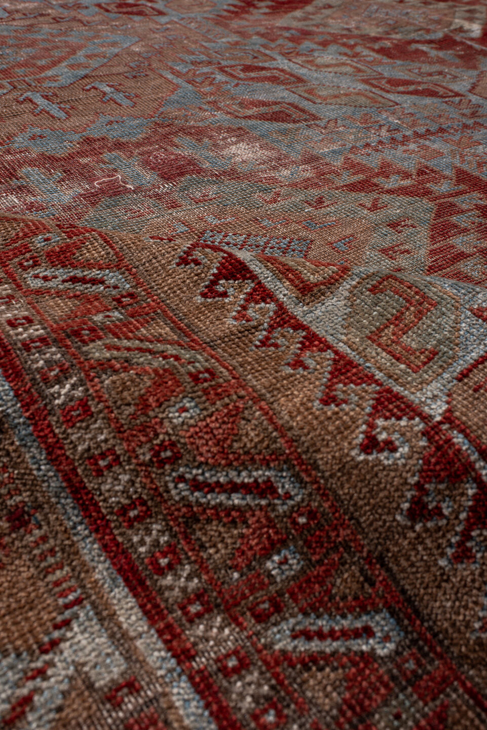6' x 9' one-of-a-kind handmade antique Belouch rug. Color palette: rust, dusty blue, ivory, taupe, burgundy, brown