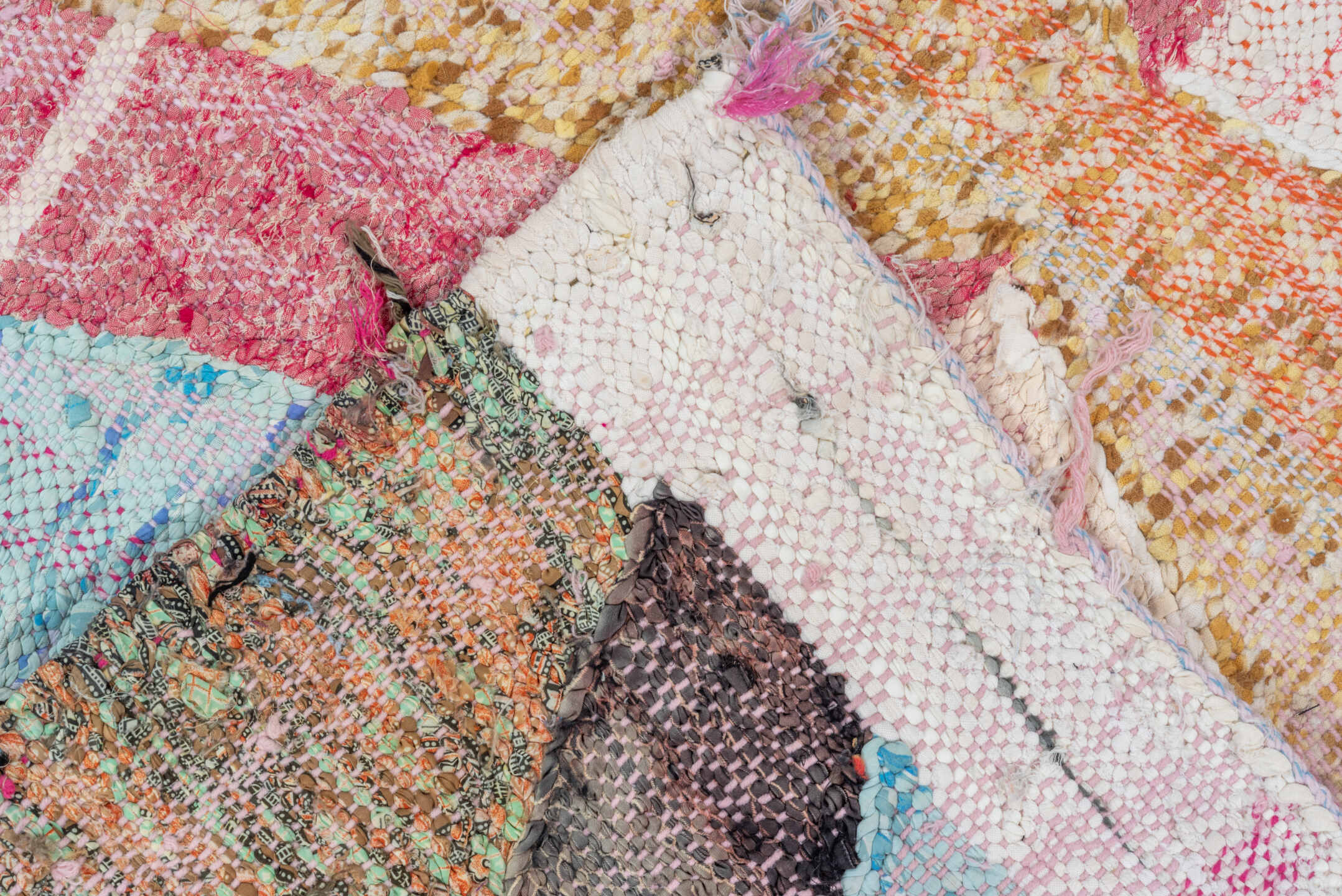 4' x 8' one-of-a-kind handmade vintage Rag Rug rug. Color palette: ivory, pink, tan, charcoal, sky_blue, taupe, orange