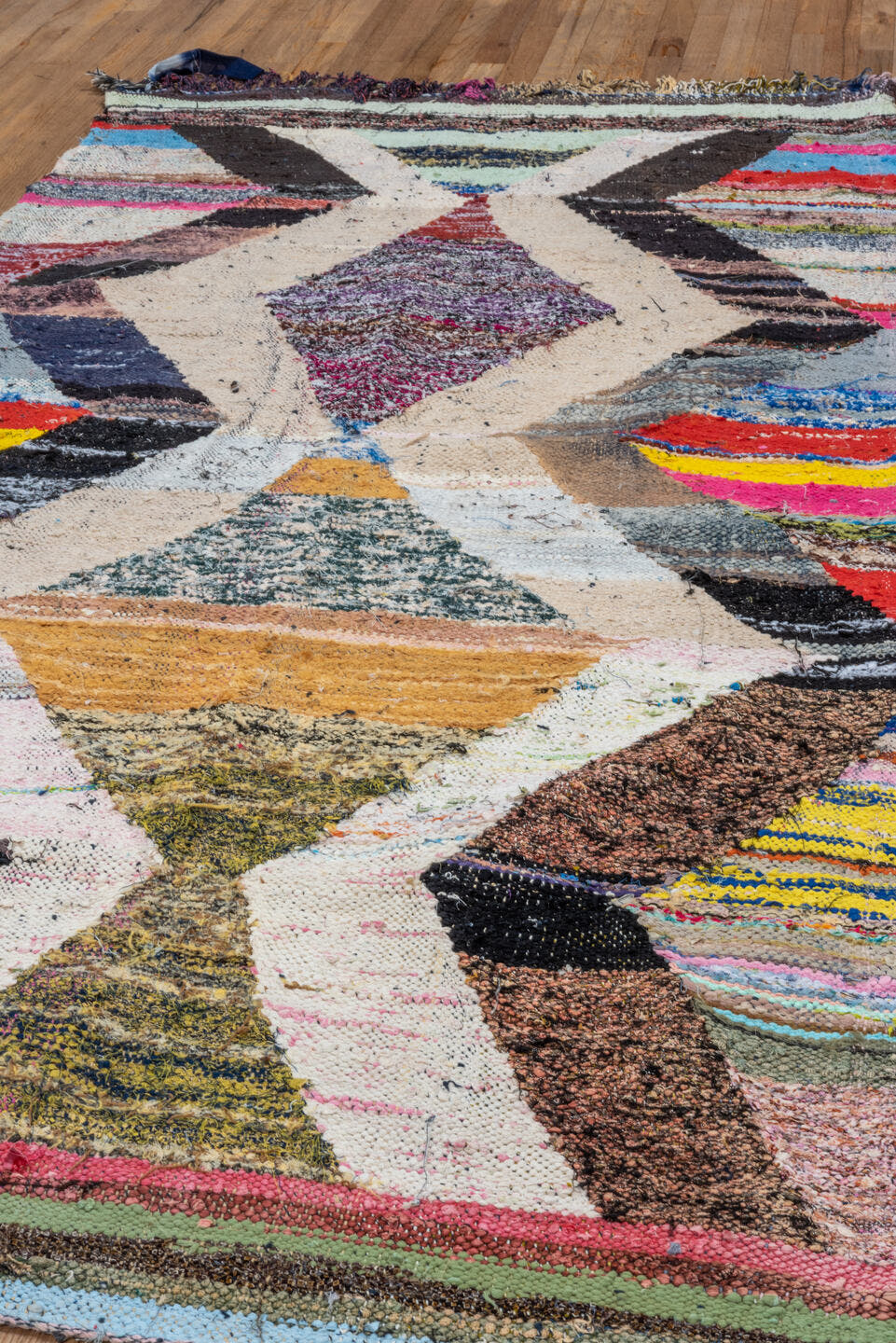 4' x 8' one-of-a-kind handmade vintage Rag Rug runner rug. Color palette: ivory, black, sky_blue, pink, yellow, rust, brown