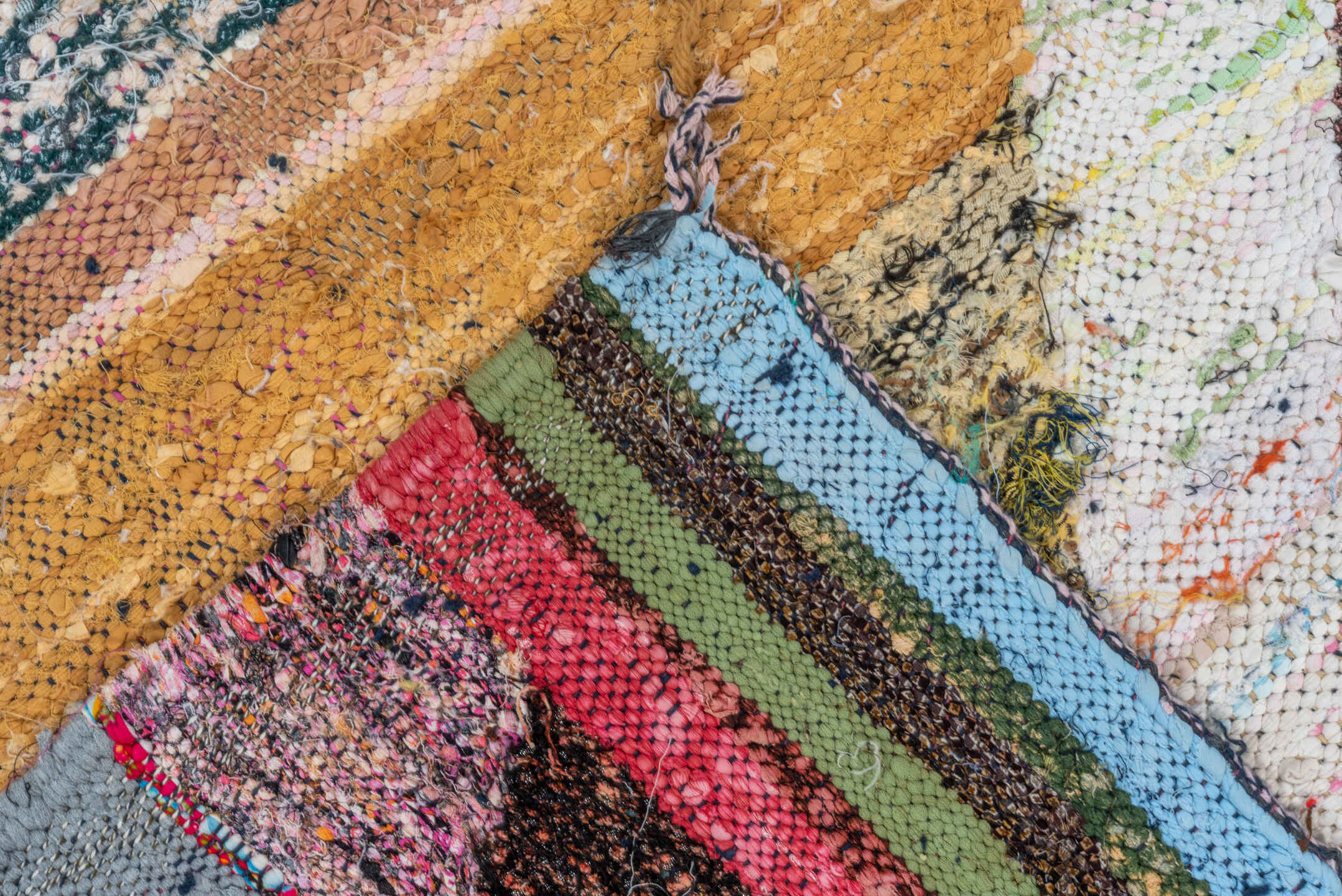 4' x 8' one-of-a-kind handmade vintage Rag Rug runner rug. Color palette: ivory, black, sky_blue, pink, yellow, rust, brown