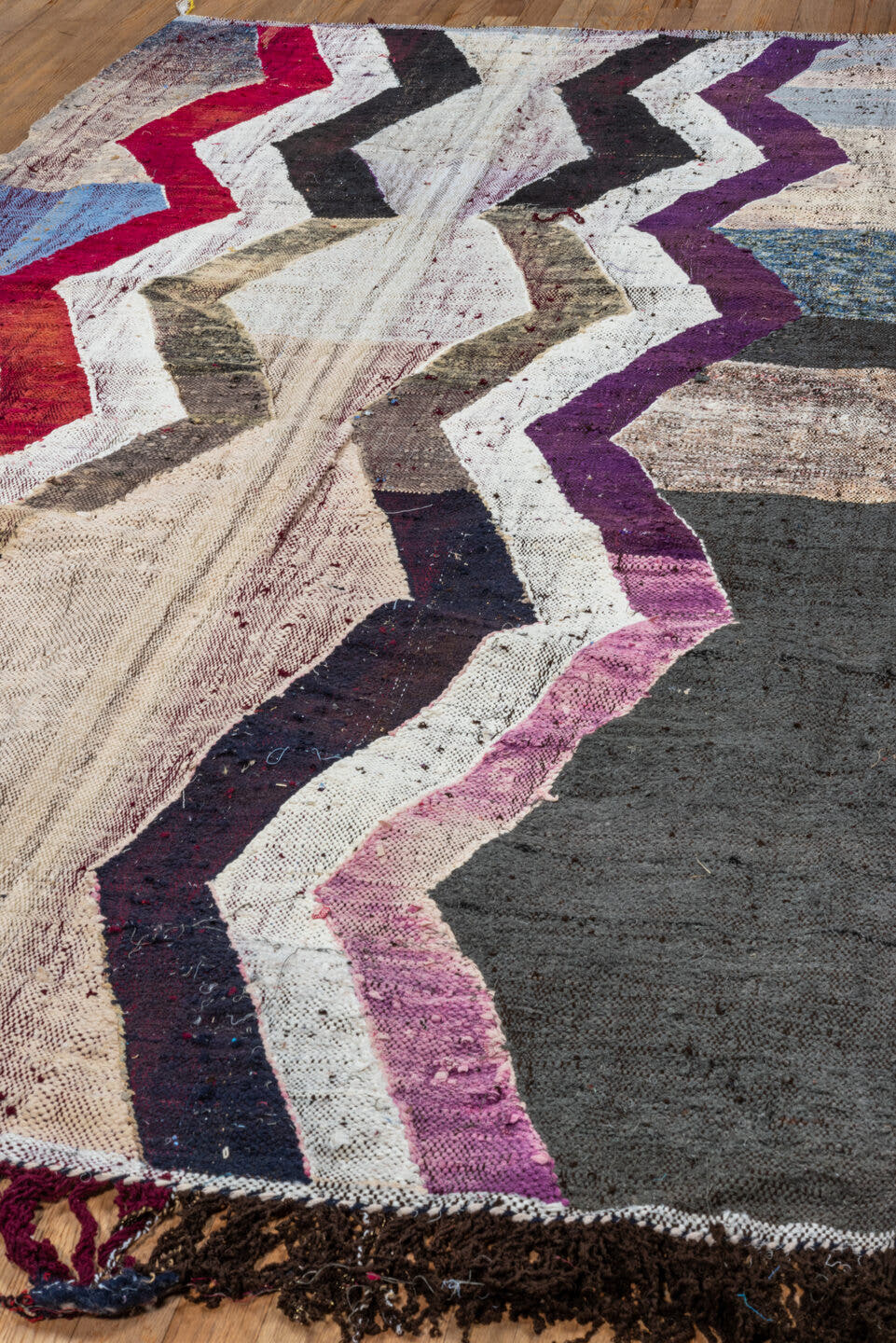 4' x 8' one-of-a-kind handmade vintage Rag Rug rug. Color palette: ivory, charcoal, plum, crimson, lavender, sky blue, brown