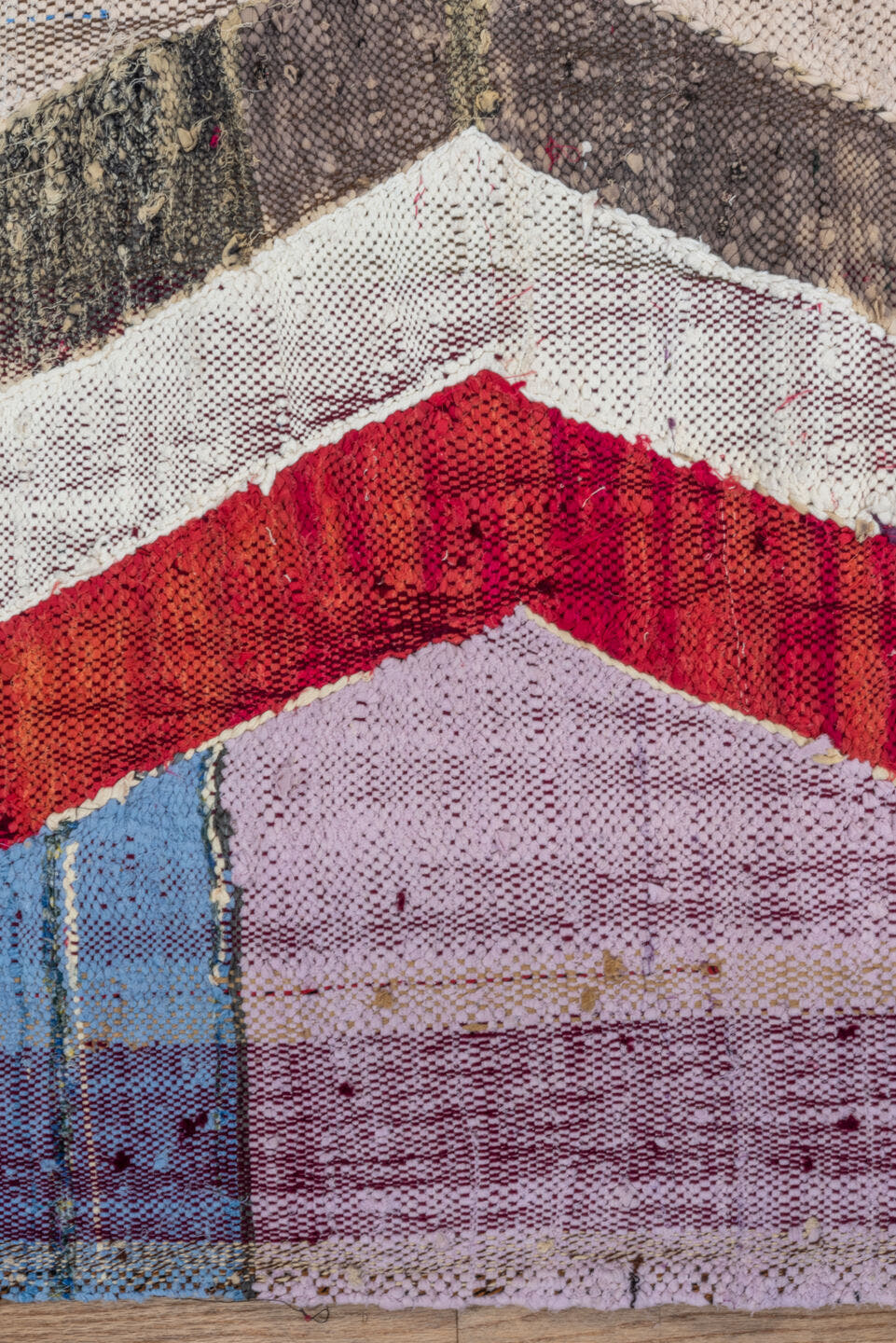 4' x 8' one-of-a-kind handmade vintage Rag Rug rug. Color palette: ivory, charcoal, plum, crimson, lavender, sky blue, brown