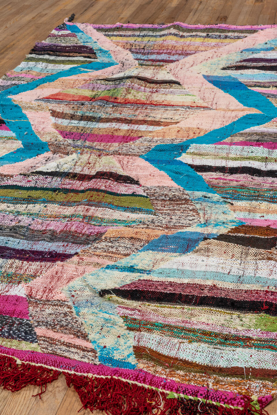 4' x 8' one-of-a-kind handmade vintage Rag Rug rug. Color palette: black, blue, brown, dark gray, gray, light gray