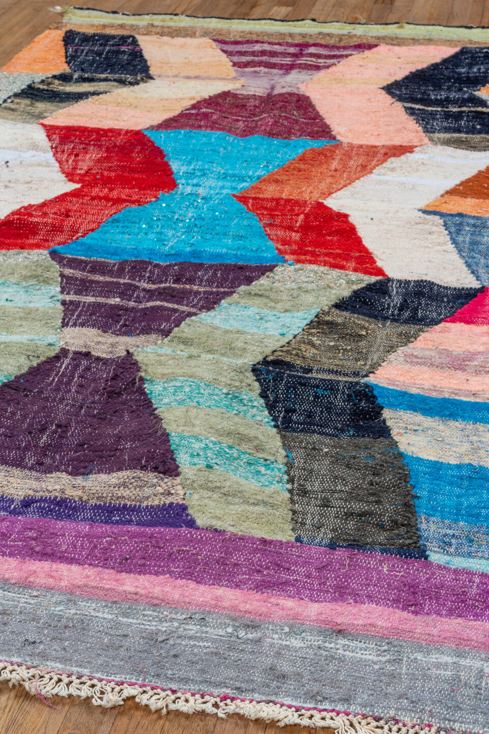 4' x 8' one-of-a-kind handmade vintage Rag Rug rug. Color palette: ivory, turquoise, navy, coral, plum, pink, orange, gray