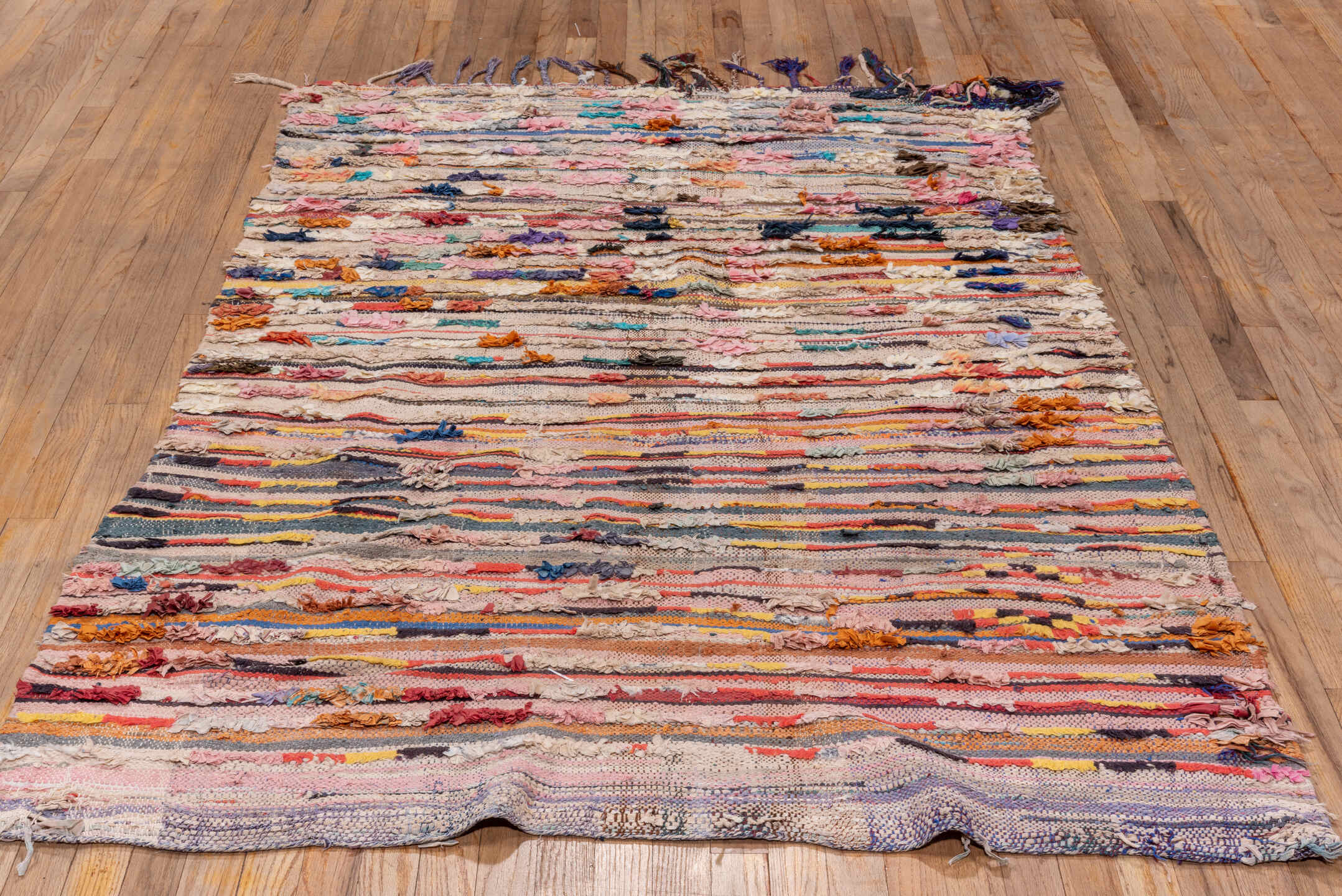 4' x 7' one-of-a-kind handmade vintage Rag Rug rug. Color palette: ivory, blush, charcoal, coral, indigo, saffron, taupe