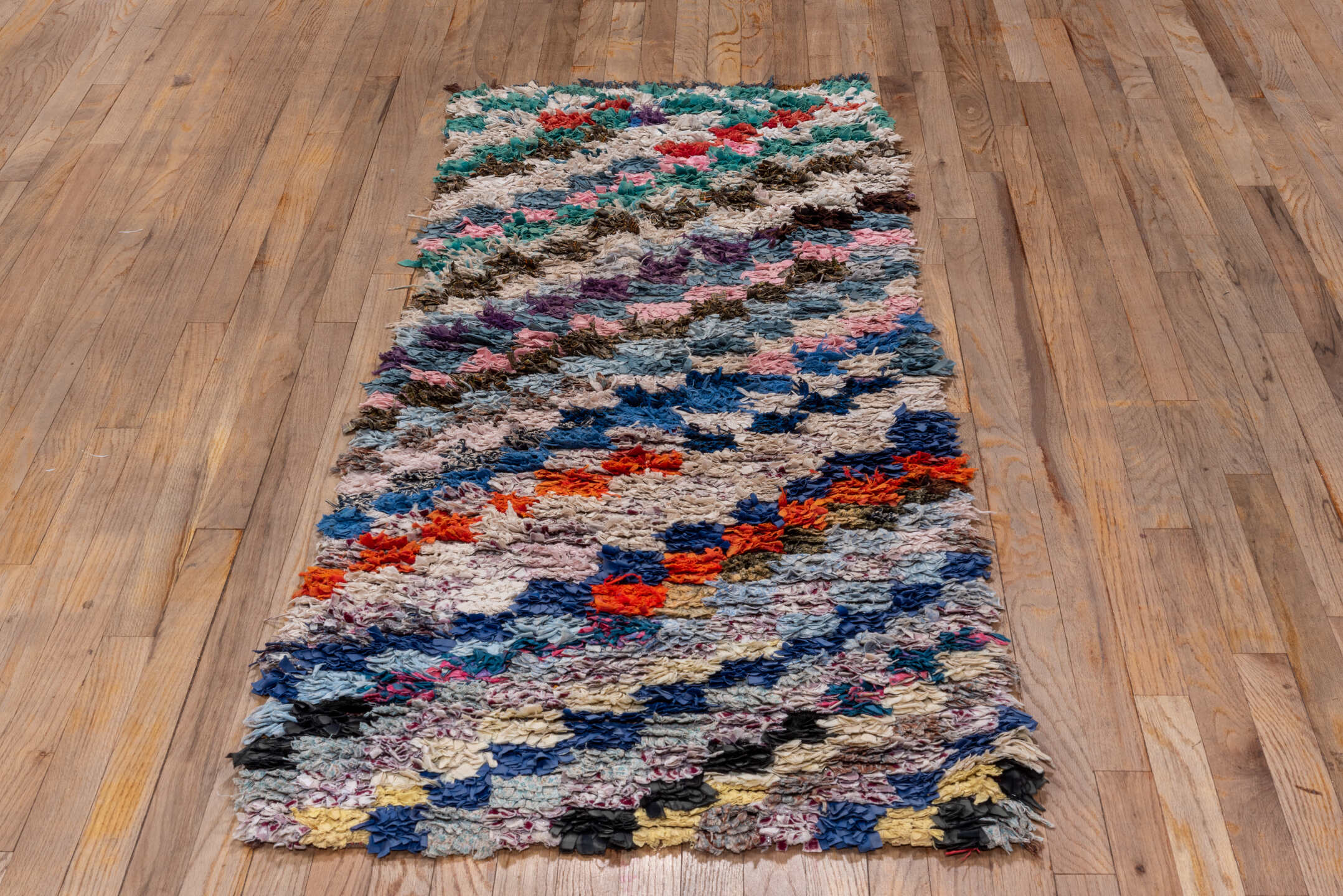 2' x 6' one-of-a-kind handmade vintage Rag Rug runner rug. Color palette: ivory, slate, turquoise, blue, brown, pink, coral