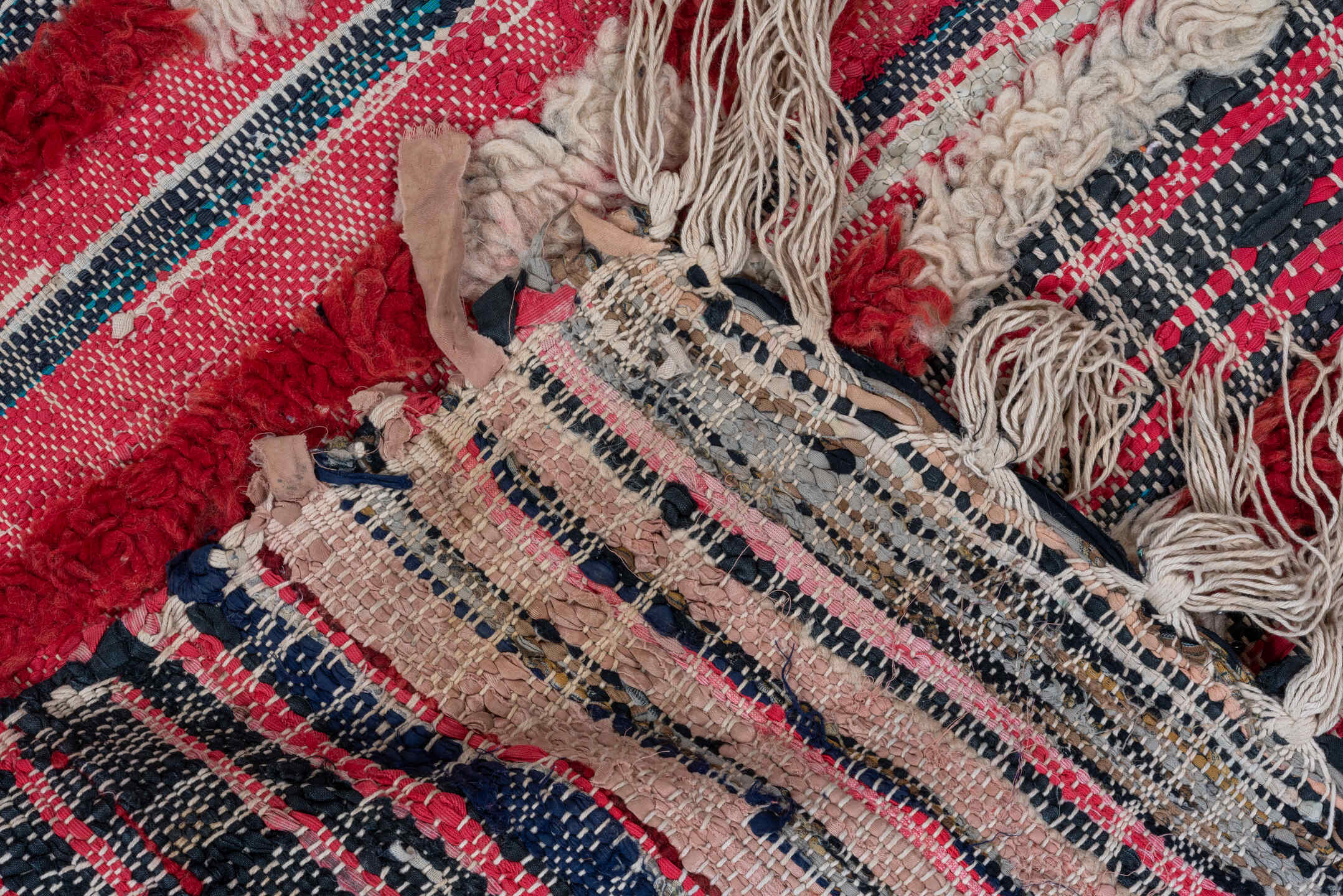 2' x 6' one-of-a-kind handmade vintage Rag Rug runner rug. Color palette: ivory, crimson, rose, charcoal, navy, gold, red