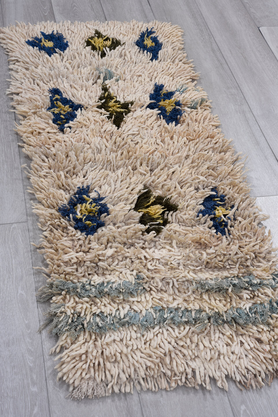 2' x 4' one-of-a-kind handmade vintage Moroccan small size rug. Color palette: black, blue, brown, gray, light gray