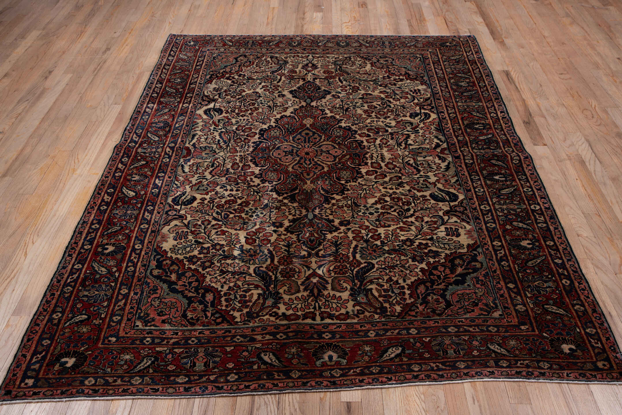 5' x 7' one-of-a-kind handmade antique Sarouk rug. Color palette: ivory, rust, navy, rose, soft blue, burgundy, taupe