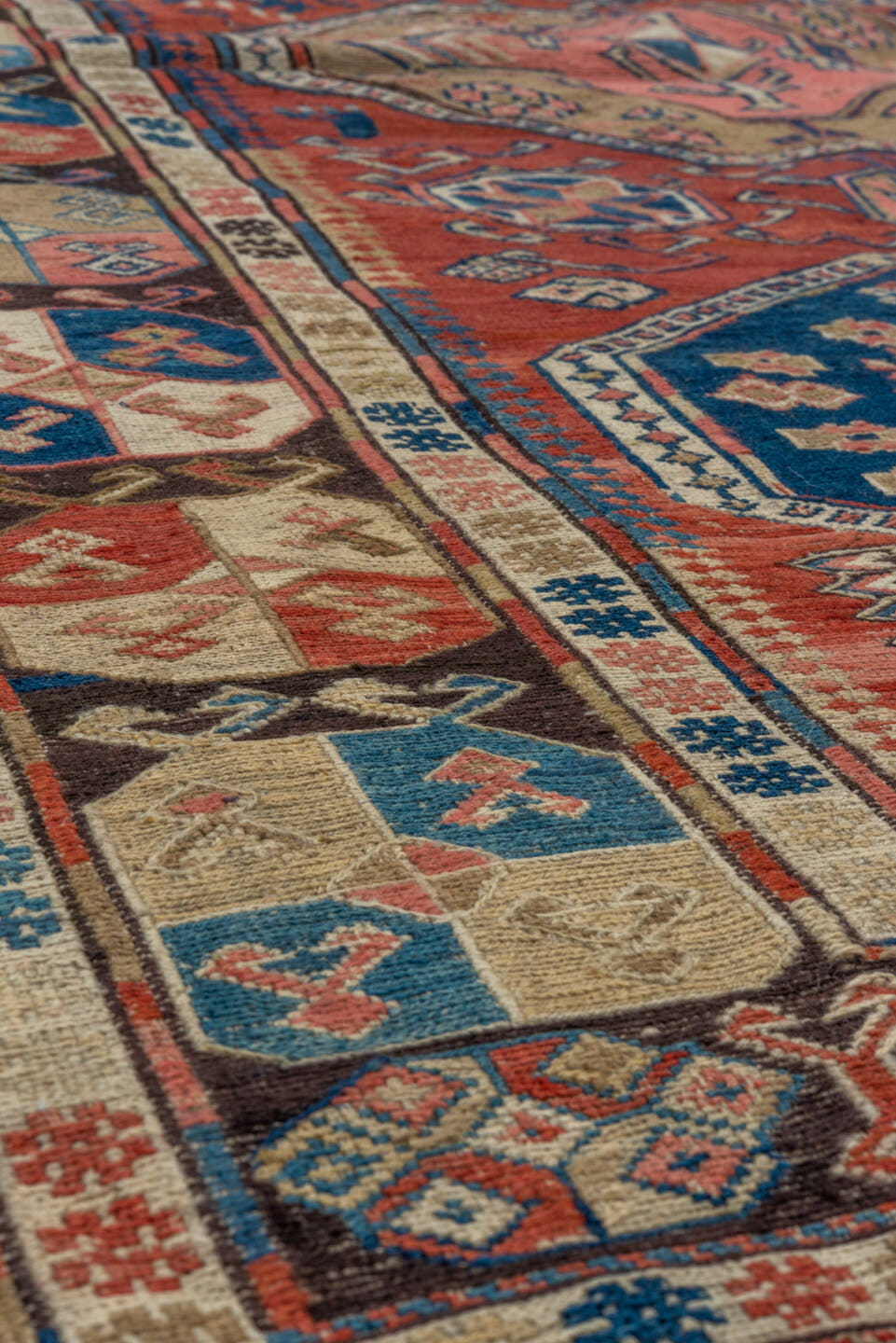 3' x 6' one-of-a-kind handmade antique Sumak small size rug. Color palette: rust, ivory, indigo, camel, charcoal, rose