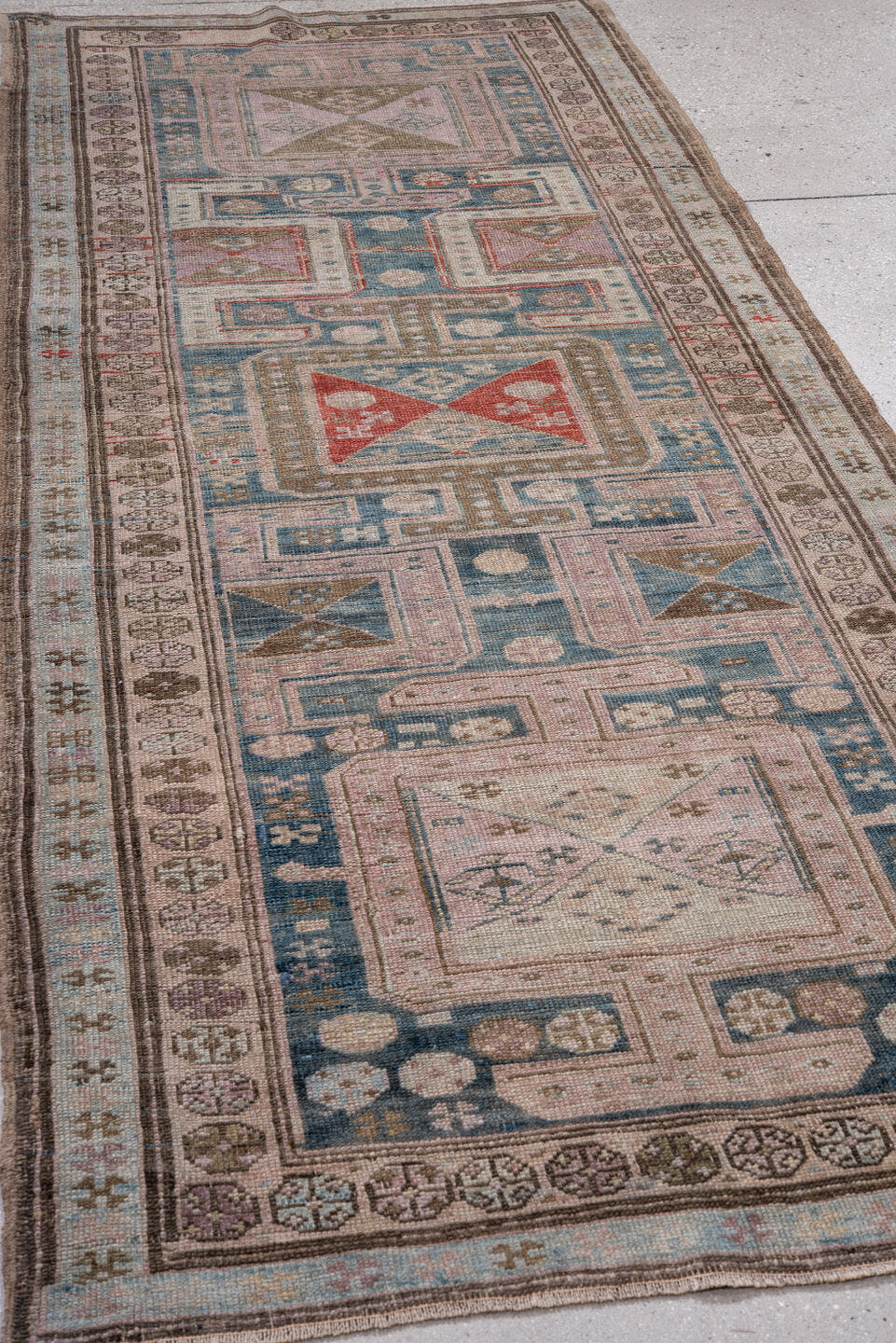 3' x 9' one-of-a-kind handmade antique Caucasian runner rug. Color palette: sky blue, ivory, taupe, brown, rust, rose, slate