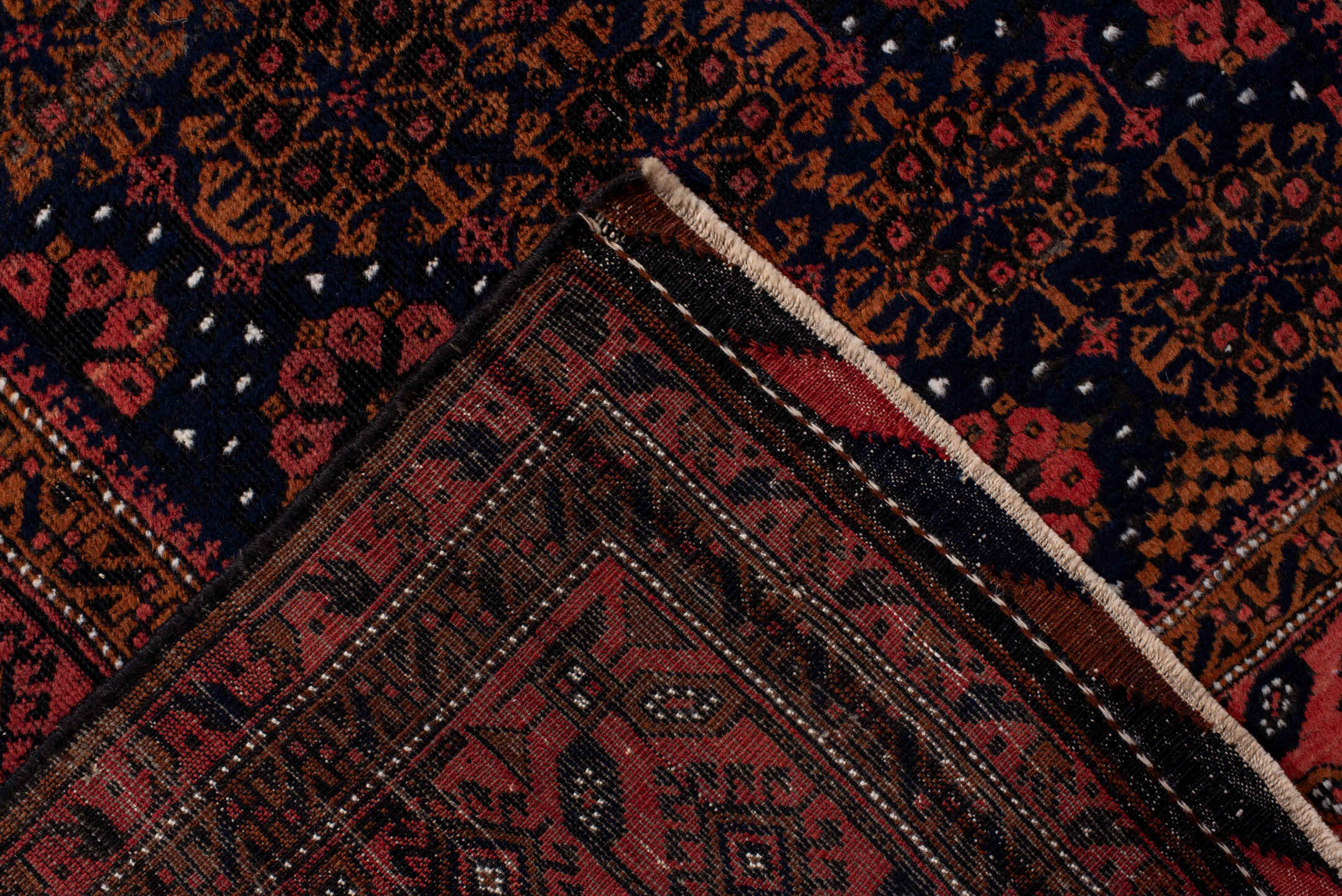 3' x 7' one-of-a-kind handmade antique Belouch rug. Color palette: rust, navy, terracotta, burgundy, camel, ivory, charcoal