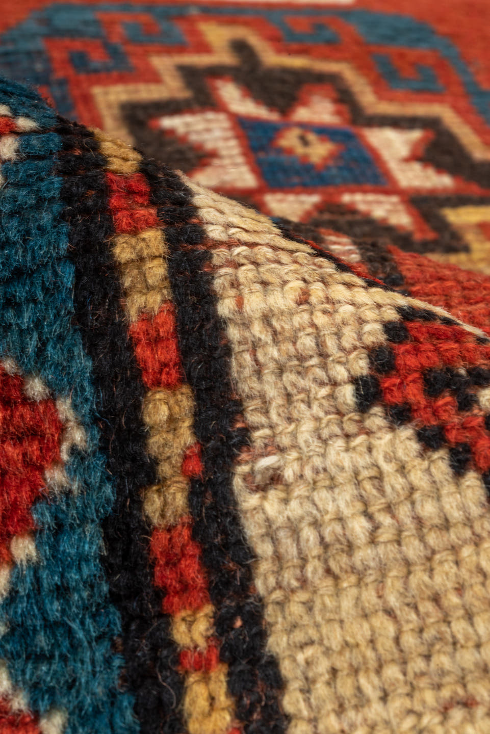 4' x 7' one-of-a-kind handmade antique Kazak rug. Color palette: rust, cobalt, ivory, camel, charcoal, gold, crimson