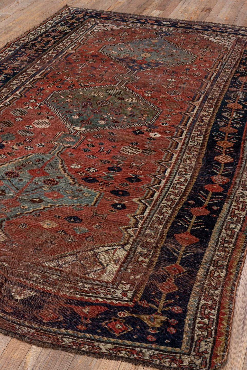 5' x 8' one-of-a-kind handmade antique Qashqai medium size rug. Color palette: rust, indigo, ivory, slate, terra cotta