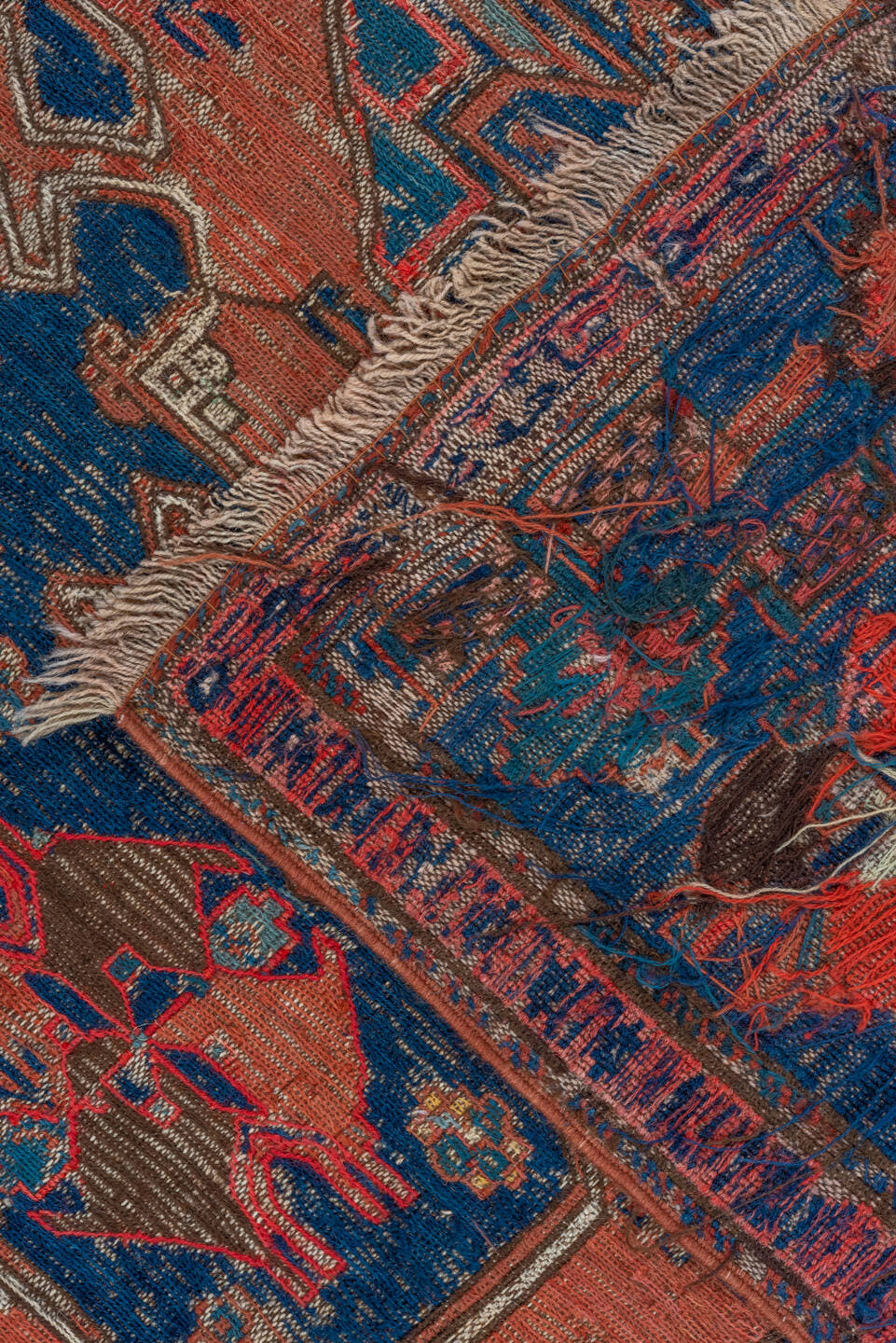 6' x 9' one-of-a-kind handmade antique Sumak medium size rug. Color palette: terra cotta, indigo, sky blue, rust, crimson