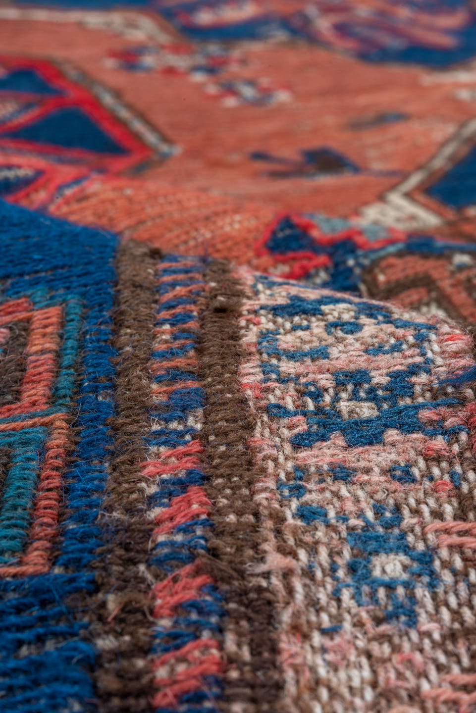 6' x 9' one-of-a-kind handmade antique Sumak medium size rug. Color palette: terra cotta, indigo, sky blue, rust, crimson