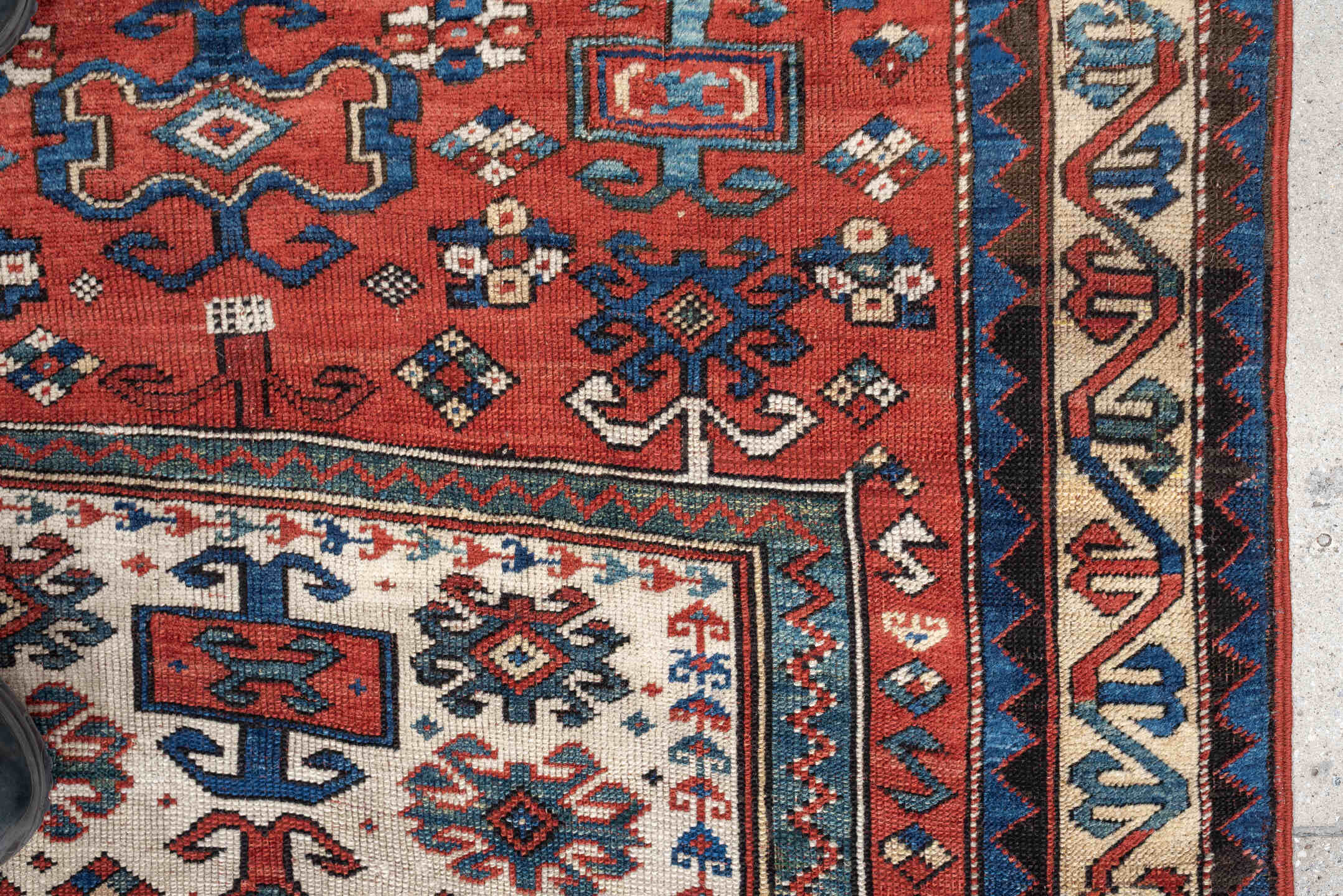 3' x 5' one-of-a-kind handmade antique Kazak small size rug. Color palette: terracotta, ivory, indigo, rust, sky_blue, navy