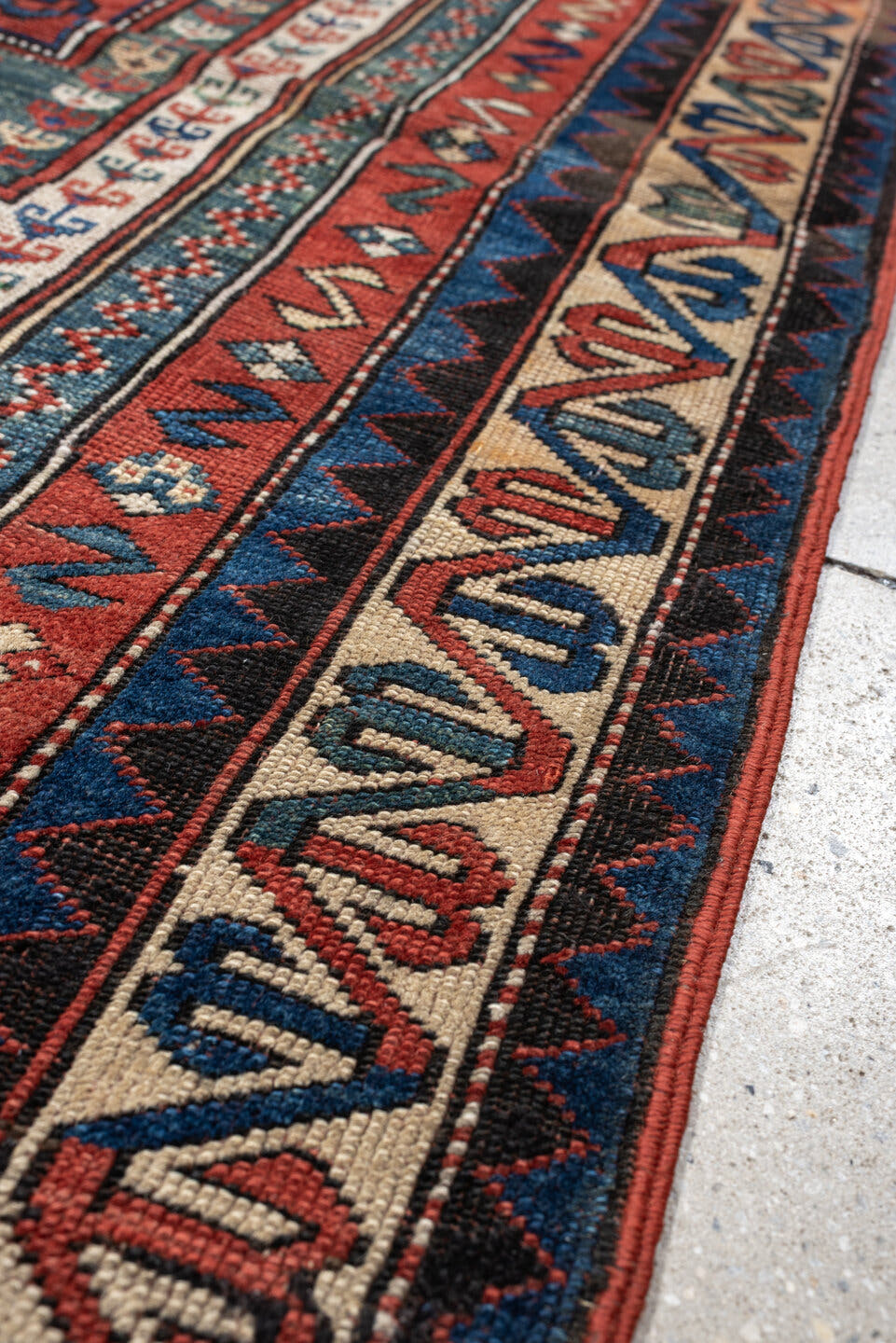 3' x 5' one-of-a-kind handmade antique Kazak small size rug. Color palette: terracotta, ivory, indigo, rust, sky_blue, navy