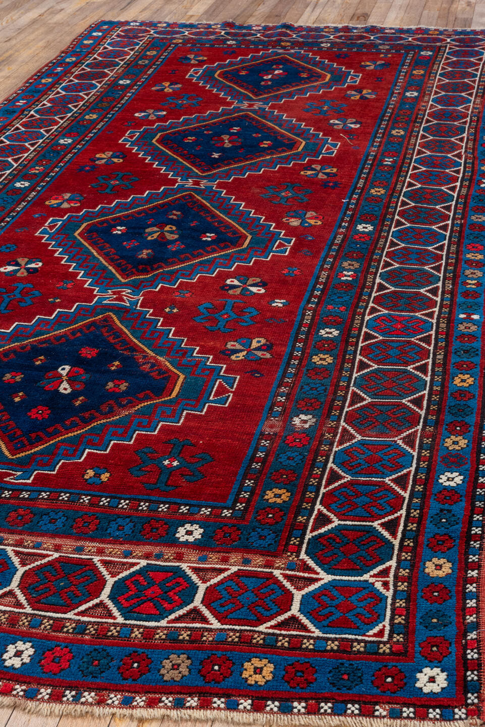 4' x 10' one-of-a-kind handmade antique Kazak runner rug. Color palette: red, navy, sky blue, ivory, crimson, charcoal, rose