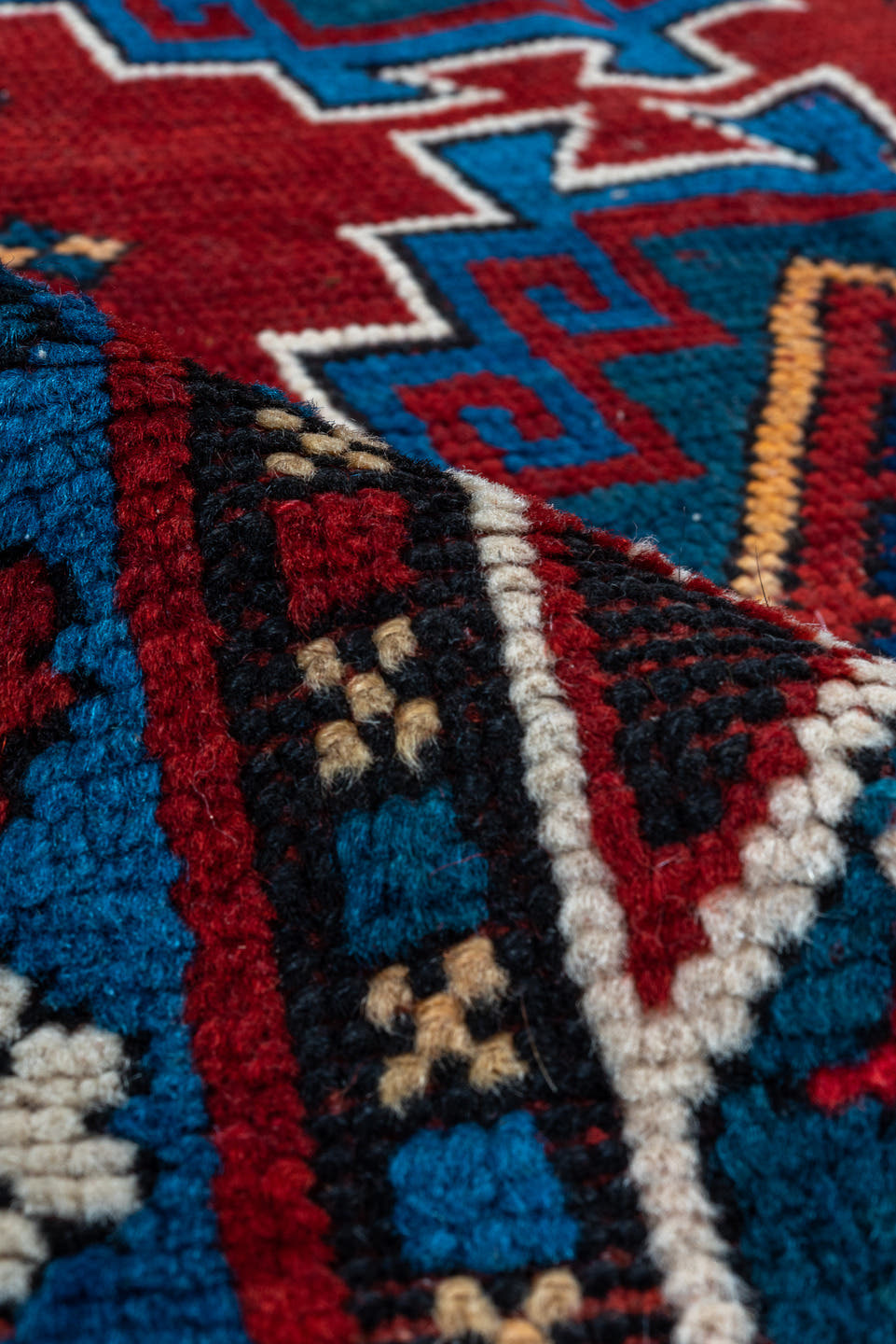 4' x 10' one-of-a-kind handmade antique Kazak runner rug. Color palette: red, navy, sky blue, ivory, crimson, charcoal, rose