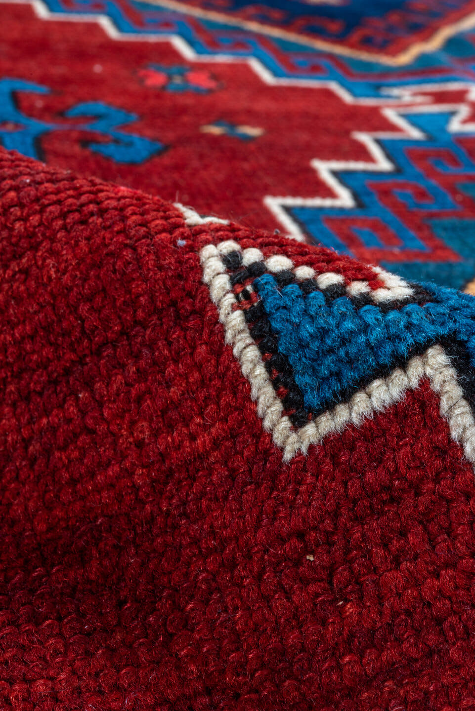 4' x 10' one-of-a-kind handmade antique Kazak runner rug. Color palette: red, navy, sky blue, ivory, crimson, charcoal, rose
