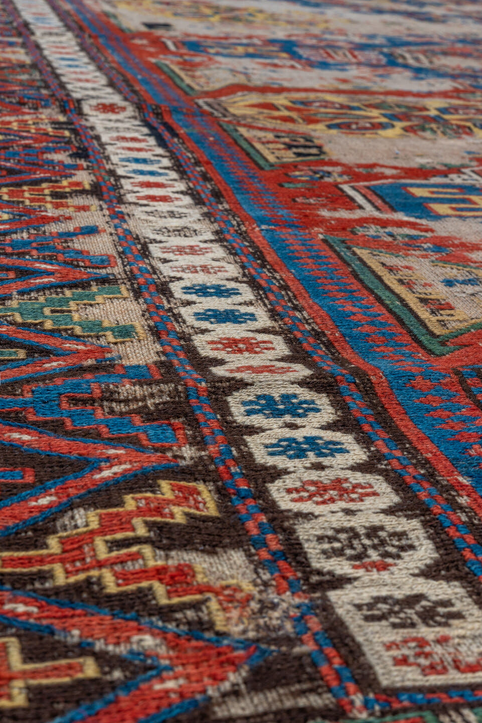 6' x 7' one-of-a-kind handmade antique Sumak rug. Color palette: ivory, indigo, rust, crimson, gold, charcoal, saffron, teal