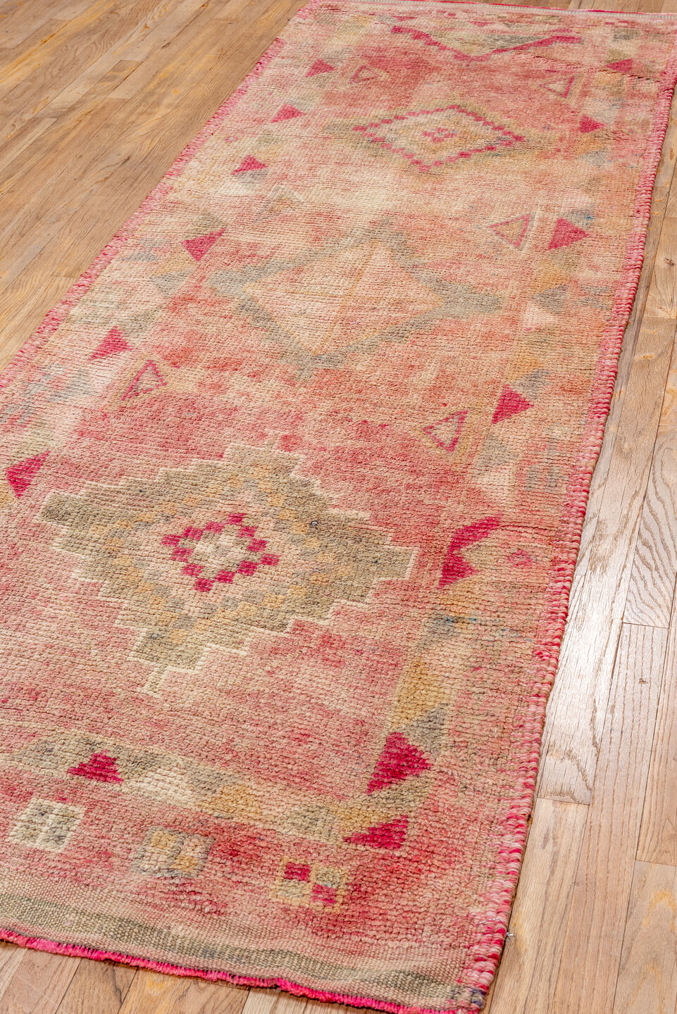 3' x 10' one-of-a-kind handmade vintage Kars runner rug. Color palette: brown, off-white, orange, pink, red, snow, white