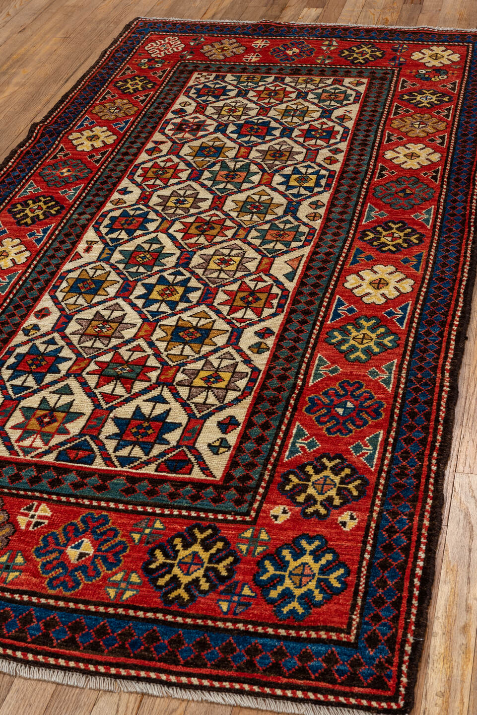 3' x 8' one-of-a-kind handmade vintage Kazak runner rug. Color palette: red, ivory, navy, sky_blue, camel, gold, brown