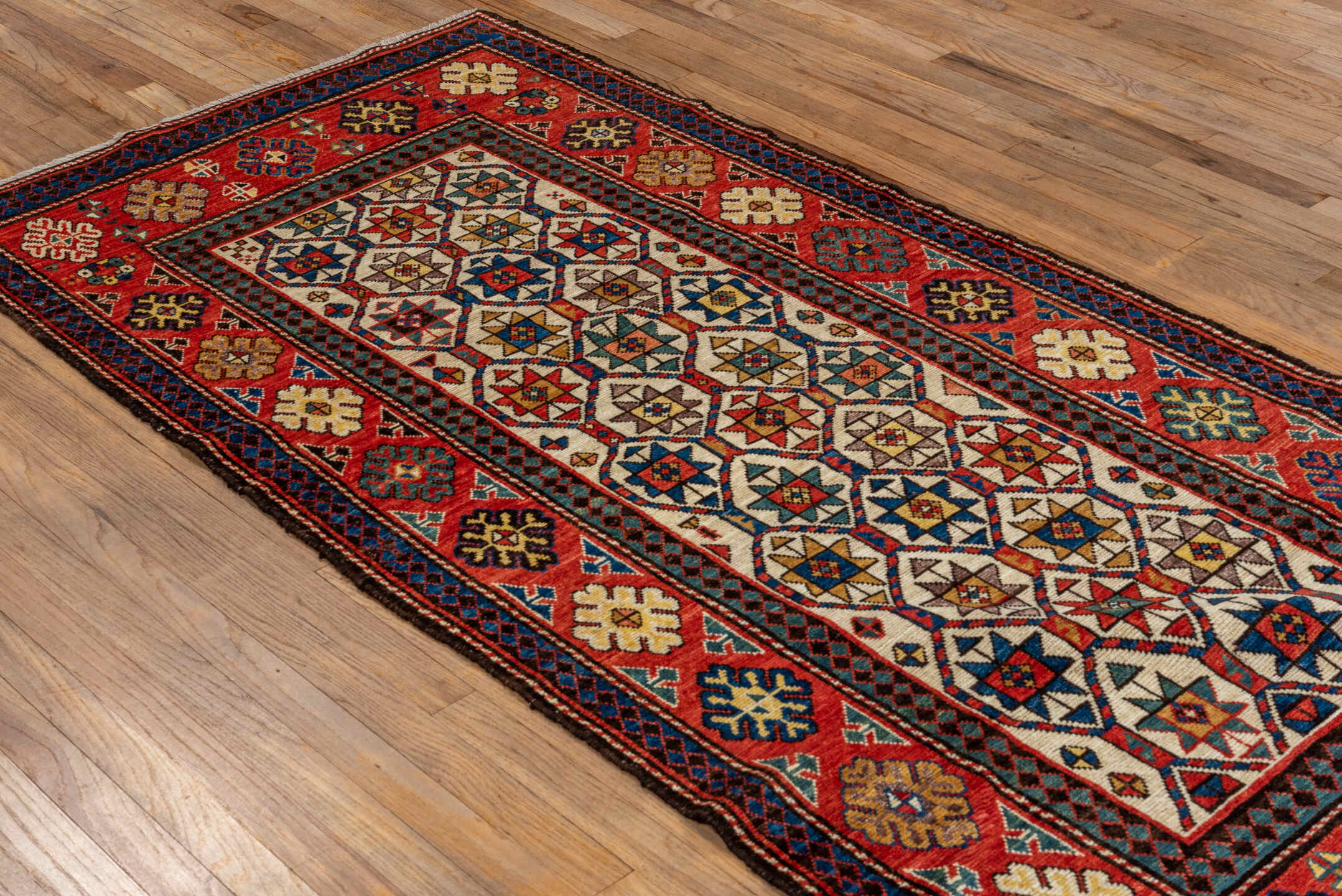 3' x 8' one-of-a-kind handmade vintage Kazak runner rug. Color palette: red, ivory, navy, sky_blue, camel, gold, brown