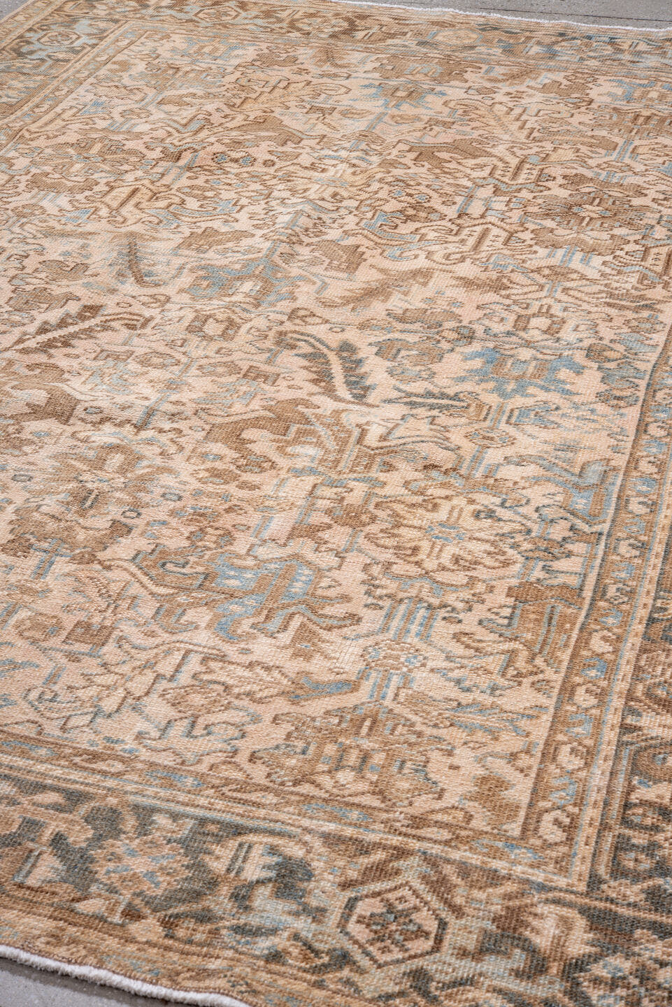 7' x 9' one-of-a-kind handmade antique Heriz rug. Color palette: ivory, taupe, sky blue, brown, camel, slate, beige, gray