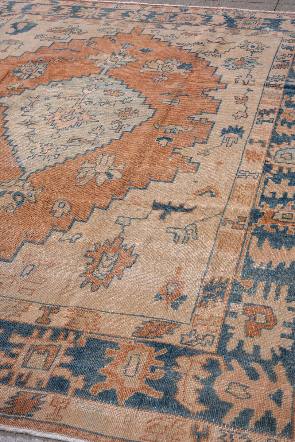 7' x 10' one-of-a-kind handmade antique Oushak large size rug. Color palette: ivory, peach, denim, sky blue, terra cotta