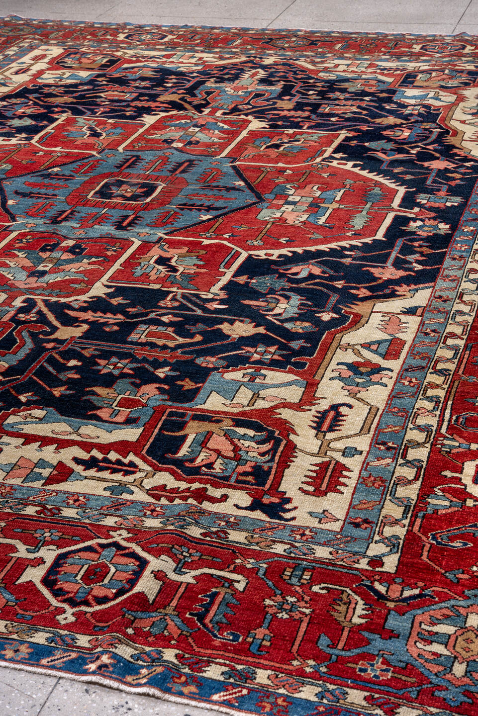 11' x 14' one-of-a-kind handmade vintage Serapi oversize rug. Color palette: brick red, navy, sky blue, ivory, coral, camel