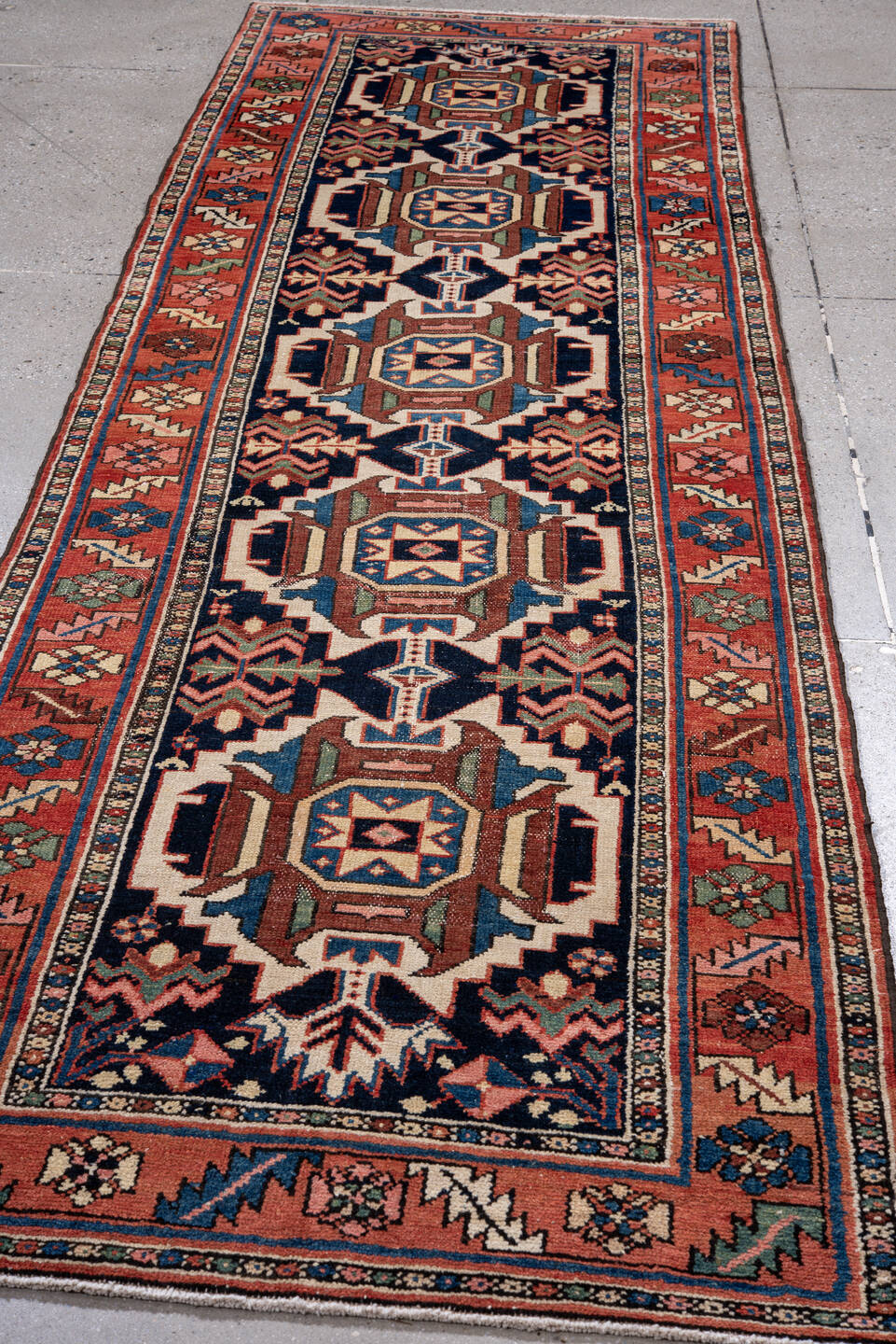 3' x 10' one-of-a-kind handmade antique Karaje runner rug. Color palette: navy, rust, ivory, sky blue, rose, sage, camel