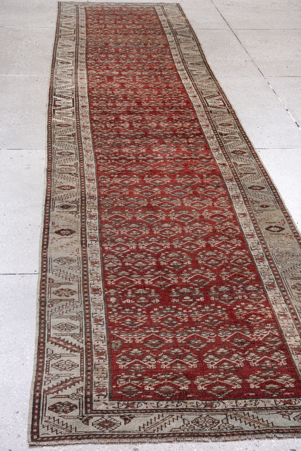 2' x 14' one-of-a-kind handmade antique Caucasian runner rug. Color palette: rust, ivory, crimson, brown, charcoal