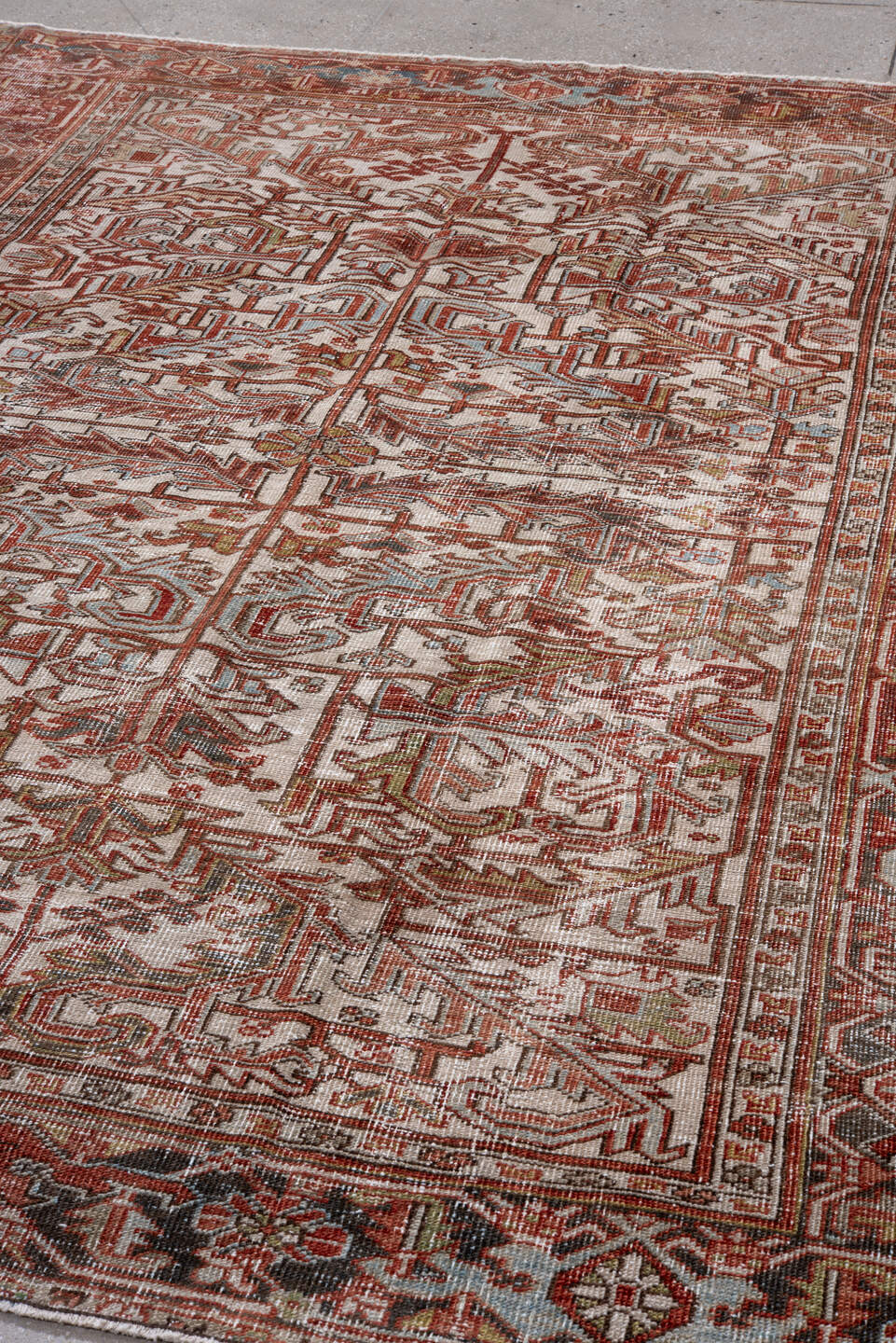 6' x 8' one-of-a-kind handmade antique Heriz rug. Color palette: ivory, rust, brick, sky blue, olive, taupe, brown, charcoal