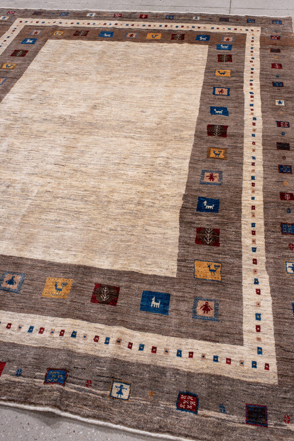 7' x 9' one-of-a-kind handmade vintage Gabbe rug. Color palette: ivory, taupe, brown, indigo, burgundy, gold, camel, beige