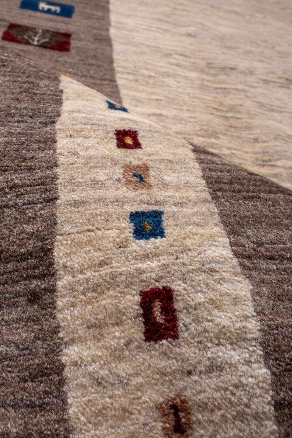 7' x 9' one-of-a-kind handmade vintage Gabbe rug. Color palette: ivory, taupe, brown, indigo, burgundy, gold, camel, beige