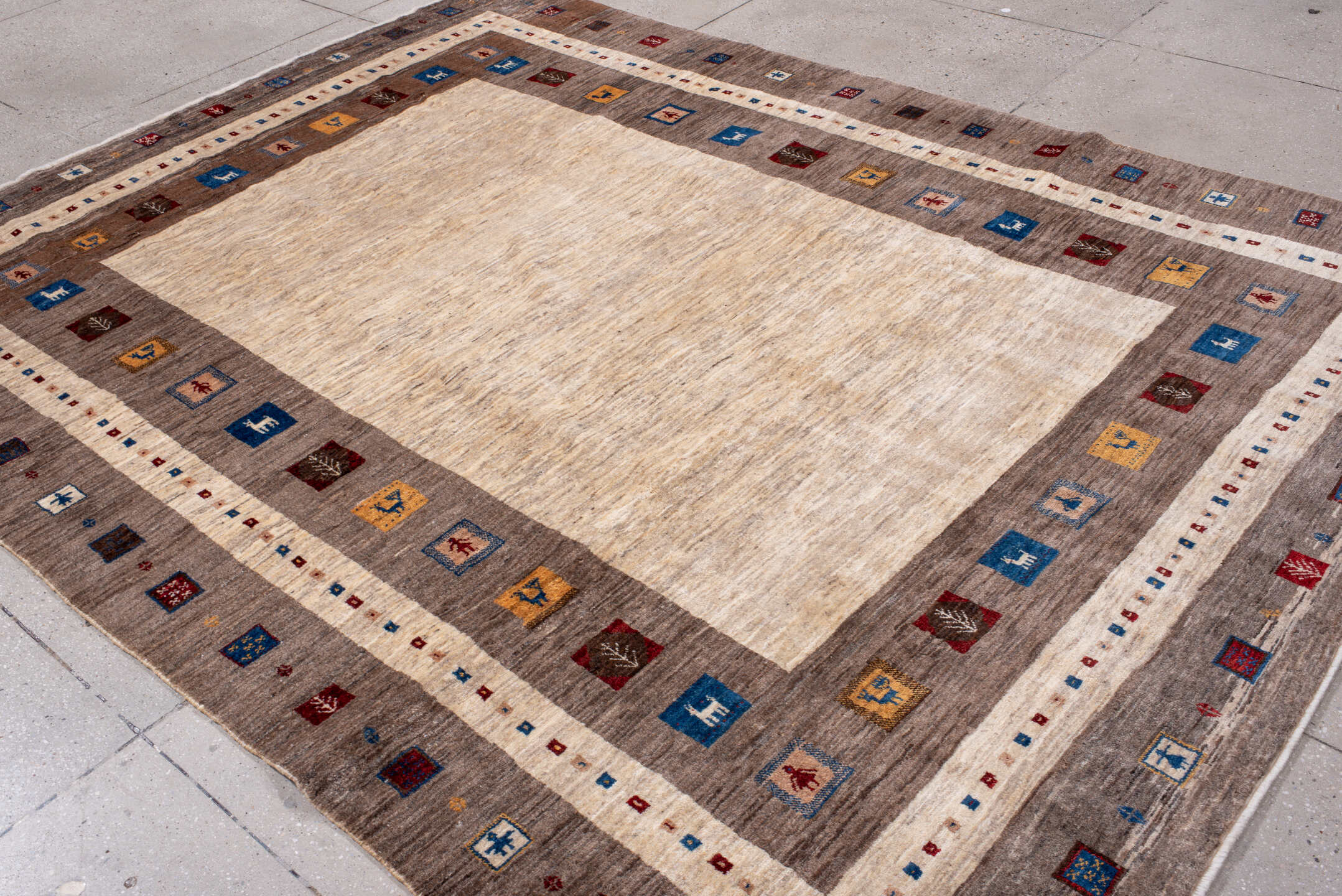 7' x 9' one-of-a-kind handmade vintage Gabbe rug. Color palette: ivory, taupe, brown, indigo, burgundy, gold, camel, beige