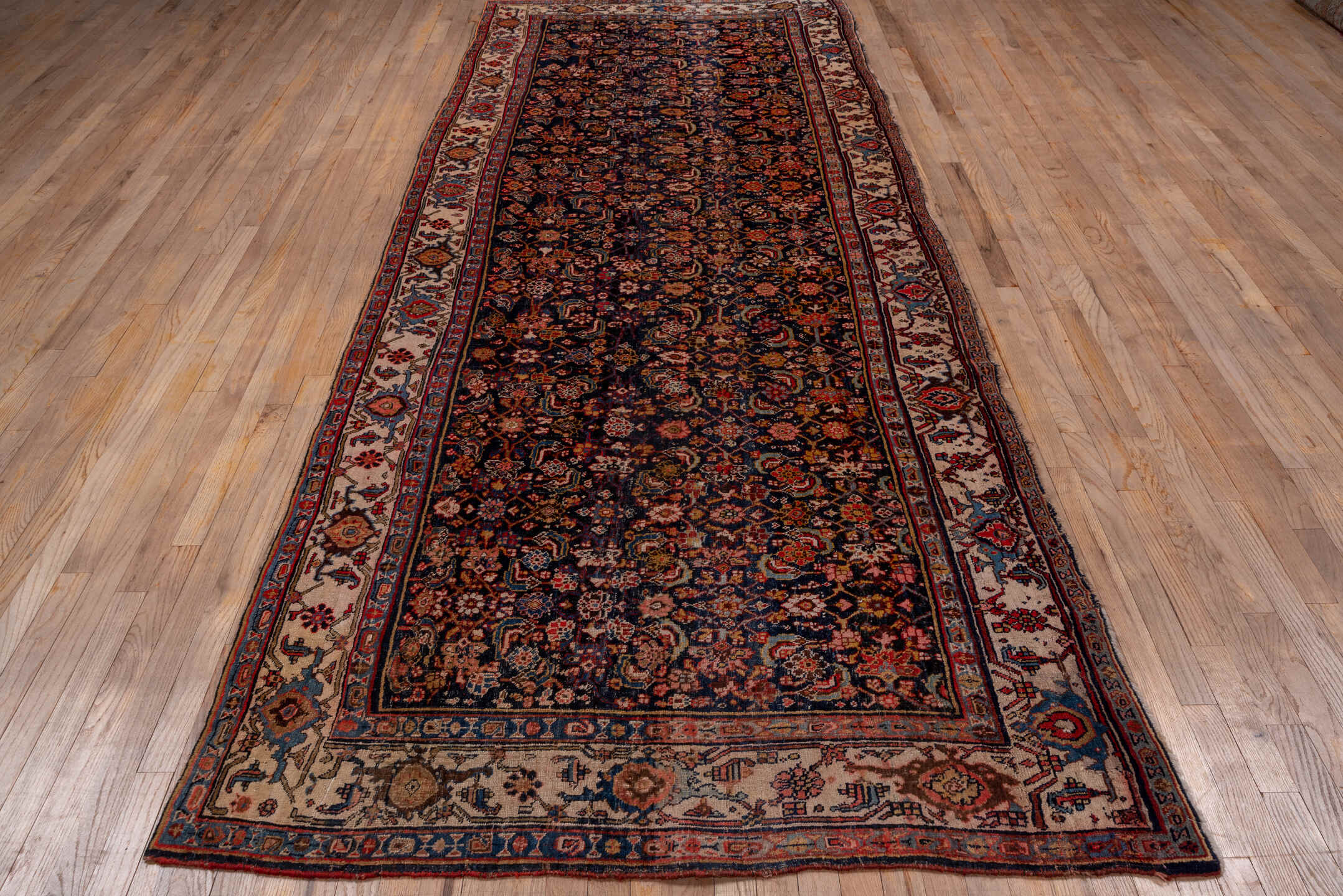 4' x 12' one-of-a-kind handmade vintage Bidjar runner rug. Color palette: black, blue, brown, gray, pink, red, redwood