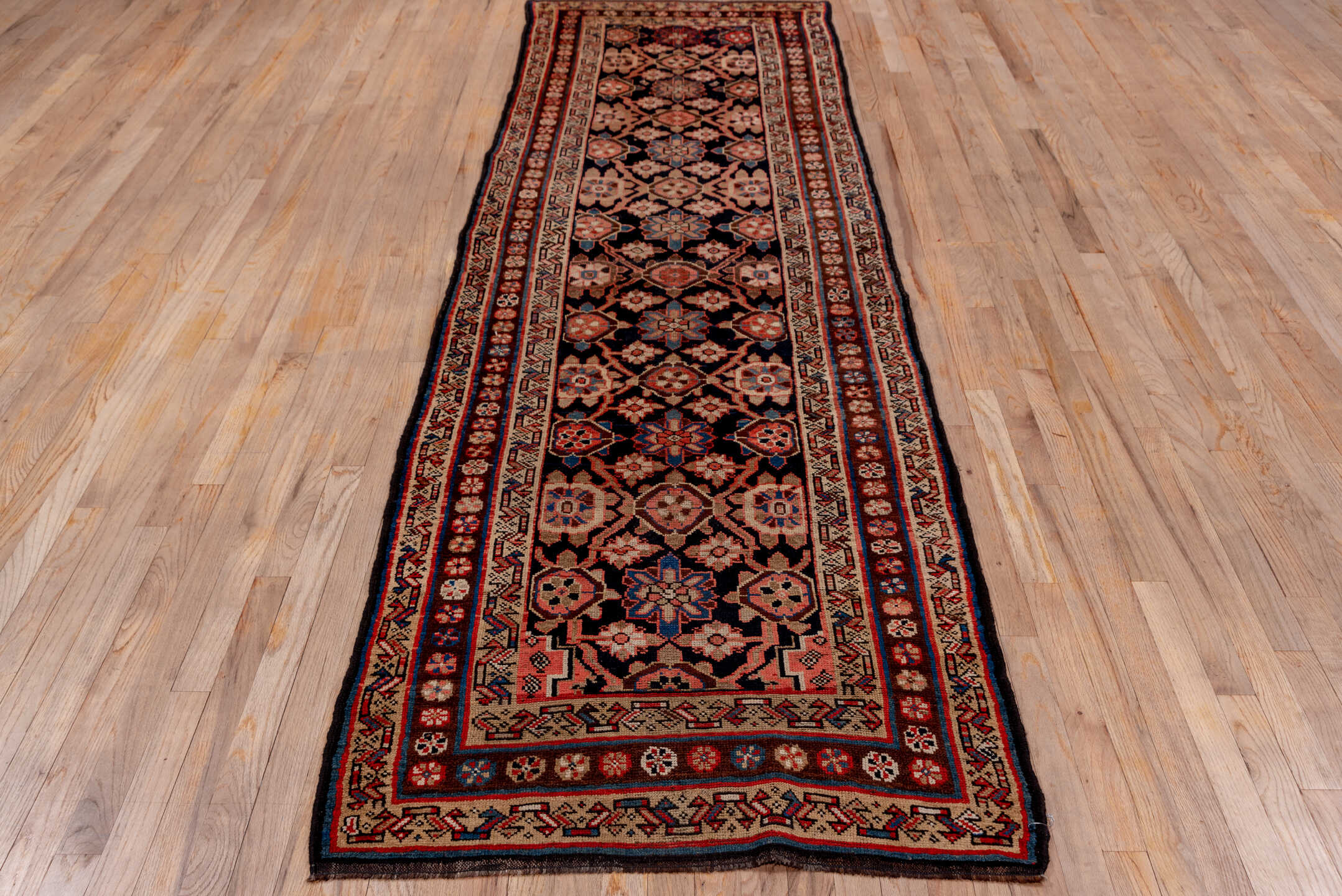 3' x 11' one-of-a-kind handmade vintage Kurd runner rug. Color palette: blue, brown, fiord, gray, pink, red, redwood