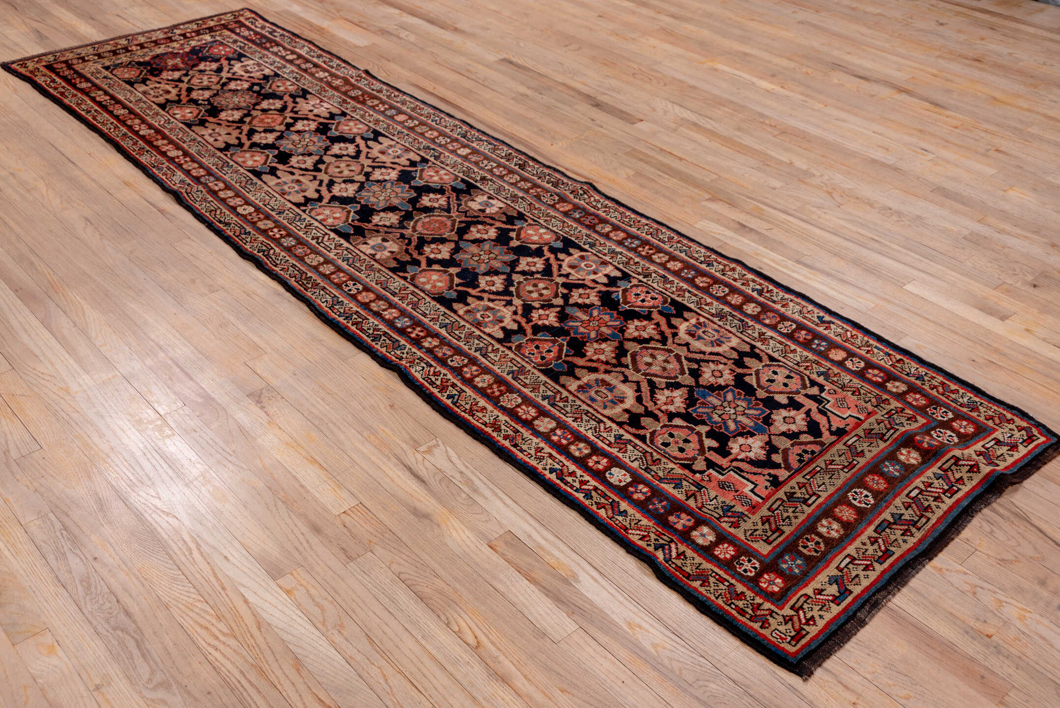 3' x 11' one-of-a-kind handmade vintage Kurd runner rug. Color palette: blue, brown, fiord, gray, pink, red, redwood