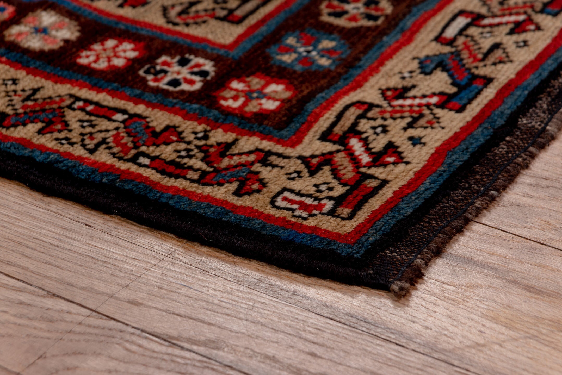 3' x 11' one-of-a-kind handmade vintage Kurd runner rug. Color palette: blue, brown, fiord, gray, pink, red, redwood