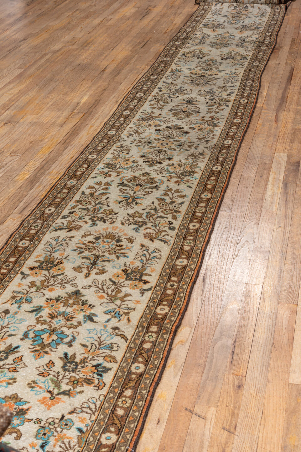 2' x 25' one-of-a-kind handmade vintage Lilian runner rug. Color palette: ivory, brown, taupe, sky blue, camel, charcoal