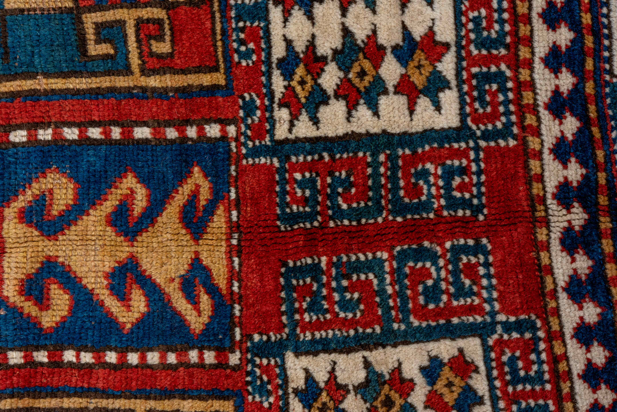 5' x 7' one-of-a-kind handmade vintage Kazak rug. Color palette: blue, brown, gray, pink, red