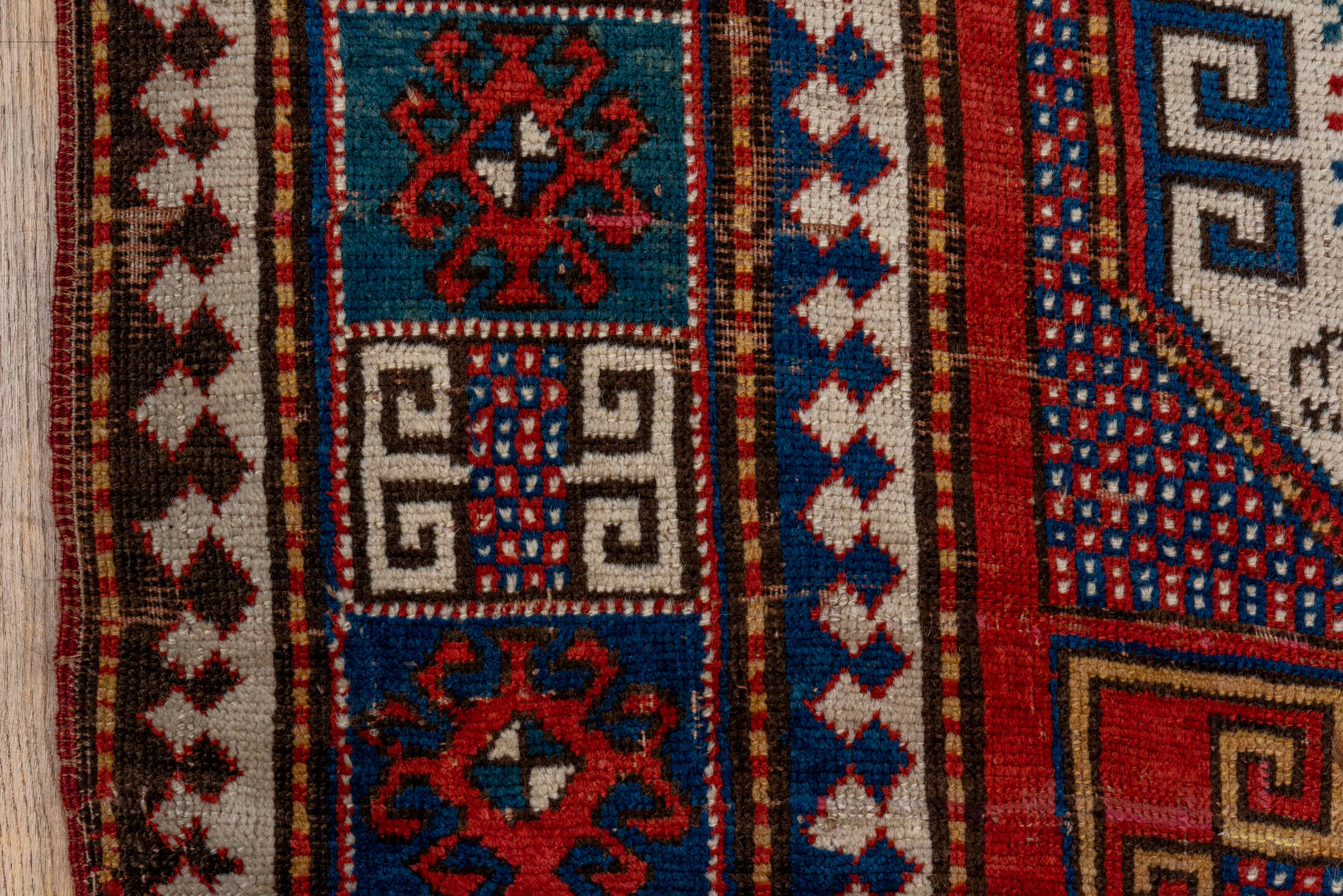 5' x 7' one-of-a-kind handmade vintage Kazak rug. Color palette: blue, brown, gray, pink, red