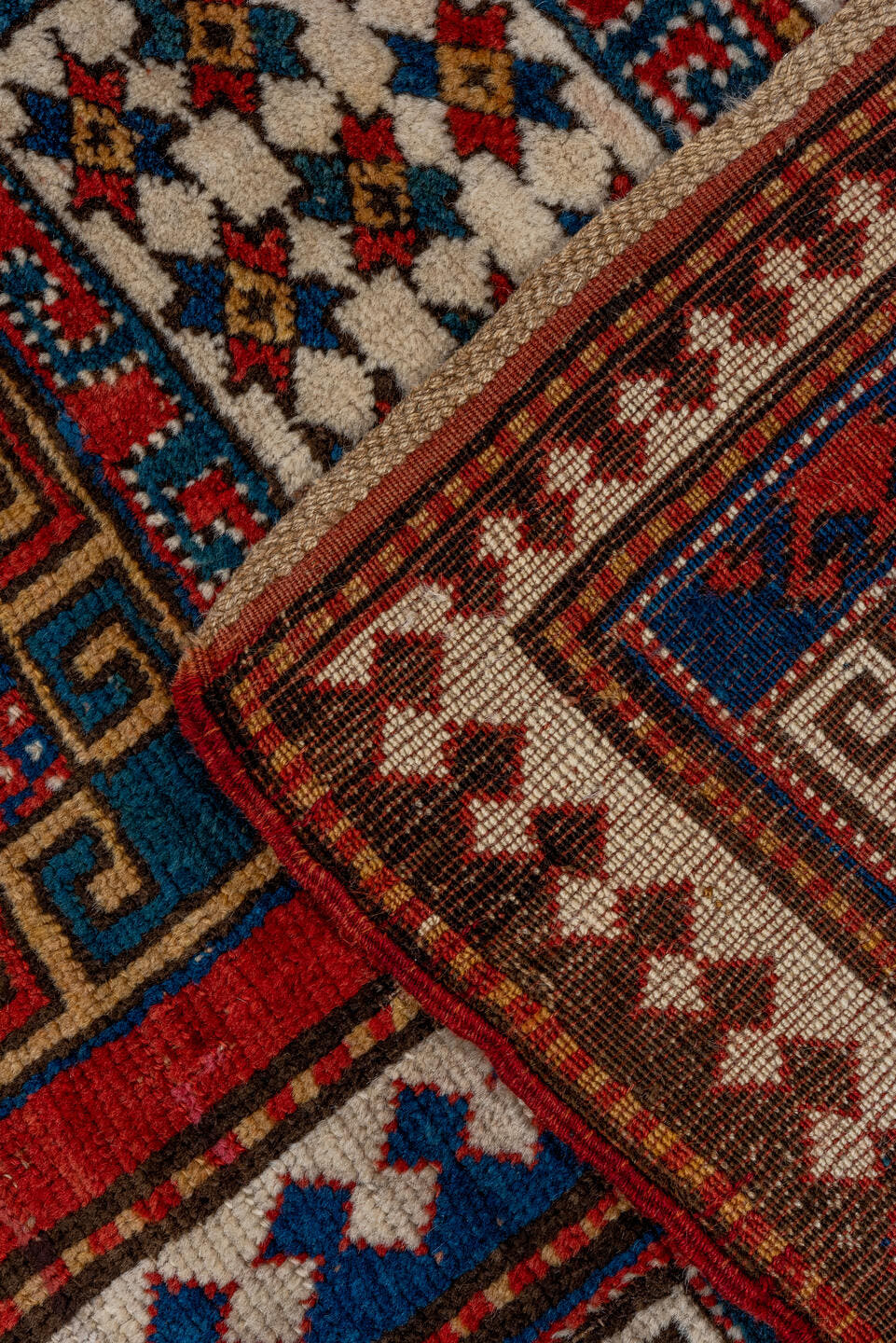 5' x 7' one-of-a-kind handmade vintage Kazak rug. Color palette: red, ivory, blue, navy, brown, rust, gold, terracotta