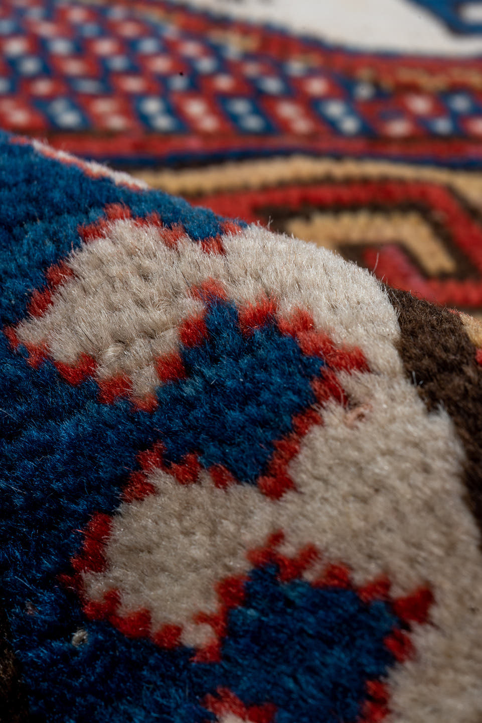 5' x 7' one-of-a-kind handmade vintage Kazak rug. Color palette: red, ivory, blue, navy, brown, rust, gold, terracotta