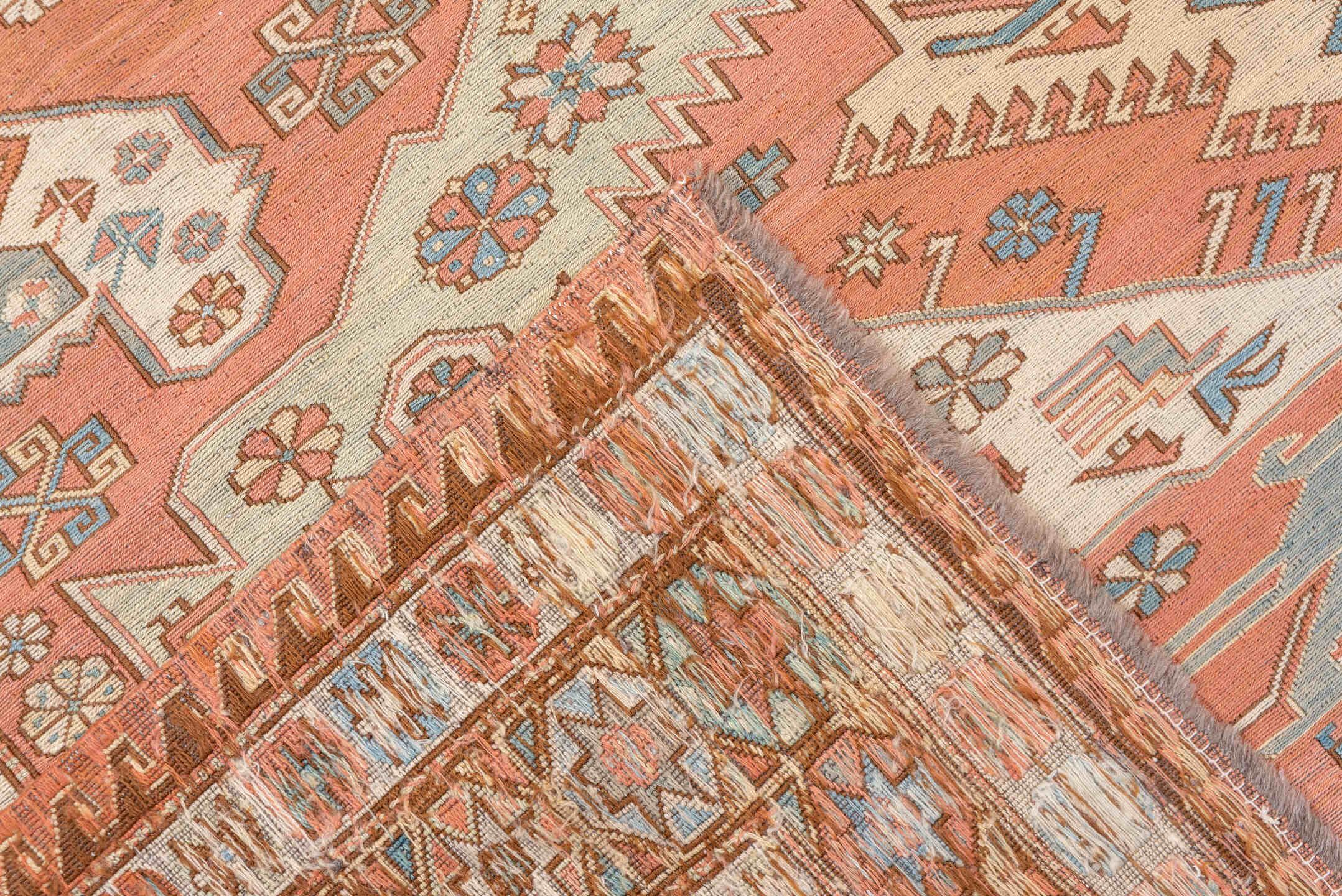 7' x 9' one-of-a-kind handmade vintage Sumak rug. Color palette: salmon, ivory, dusty blue, taupe, rust, beige, pink, blue