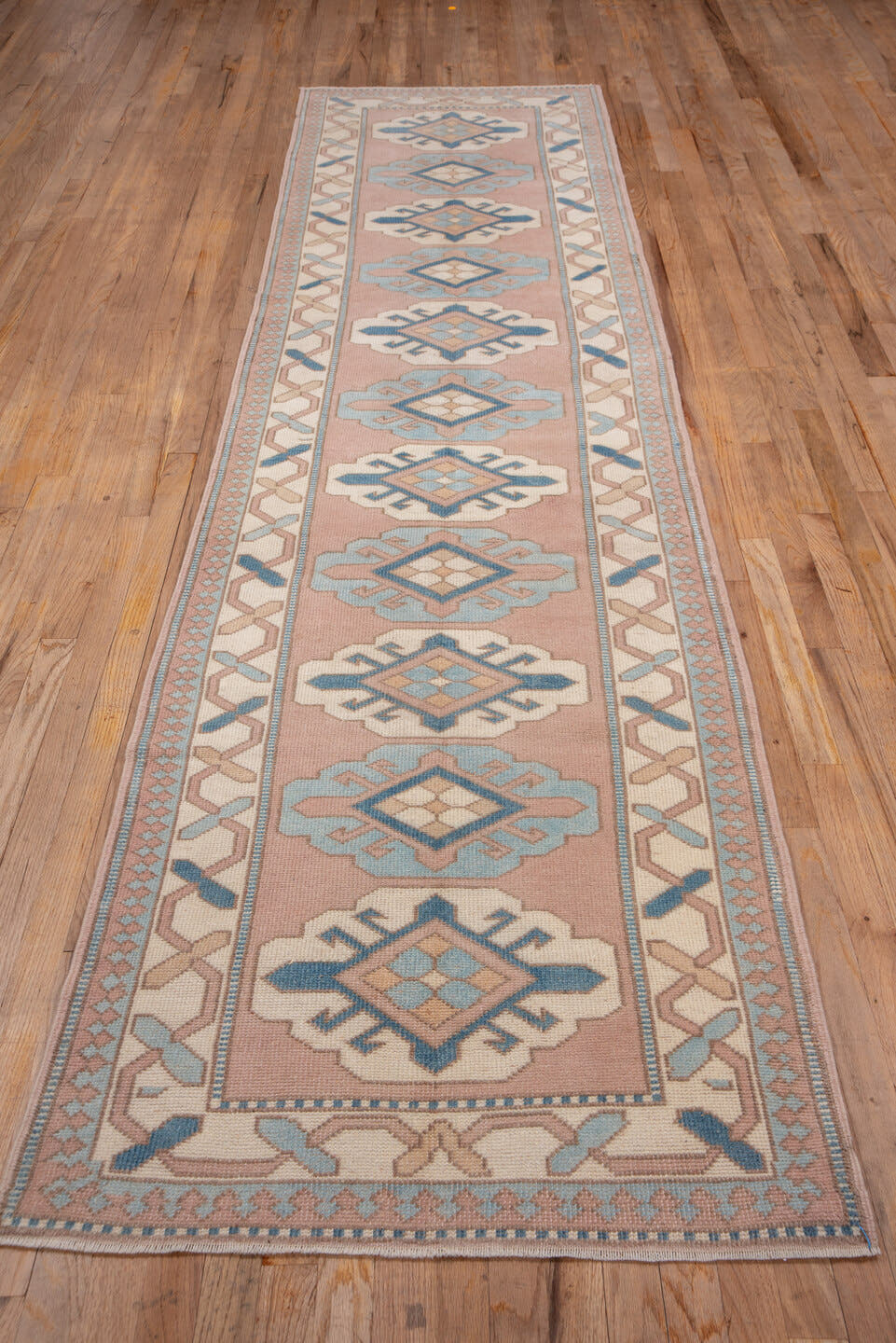 2' x 12' one-of-a-kind handmade vintage Oushak runner rug. Color palette: blush, ivory, powder_blue, denim, taupe, pink