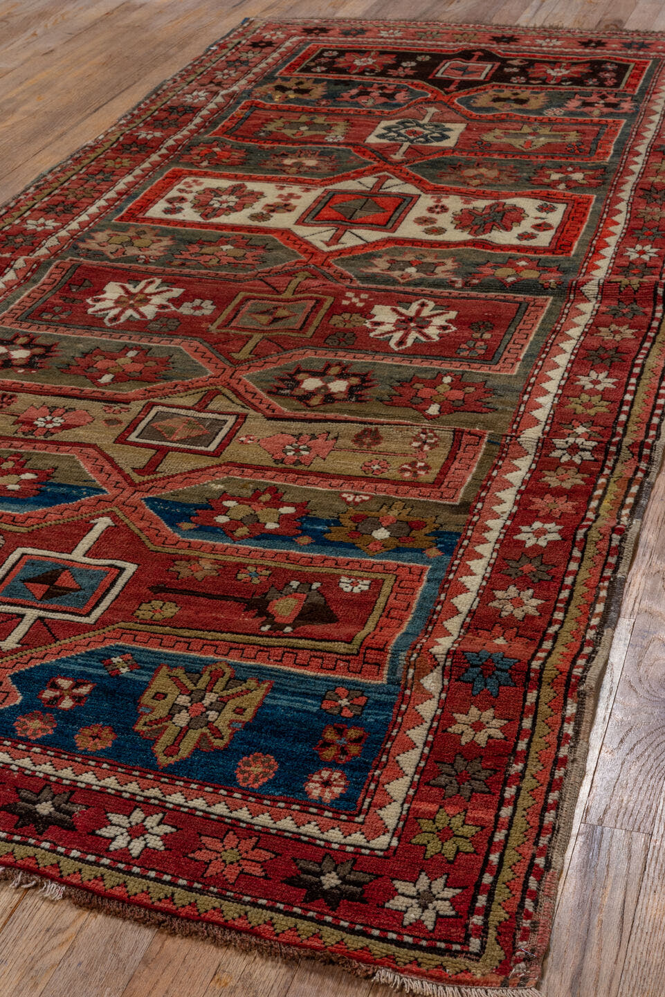 3' x 8' one-of-a-kind handmade vintage Kazak runner rug. Color palette: red, ivory, brown, blue, charcoal, rust, rose, taupe